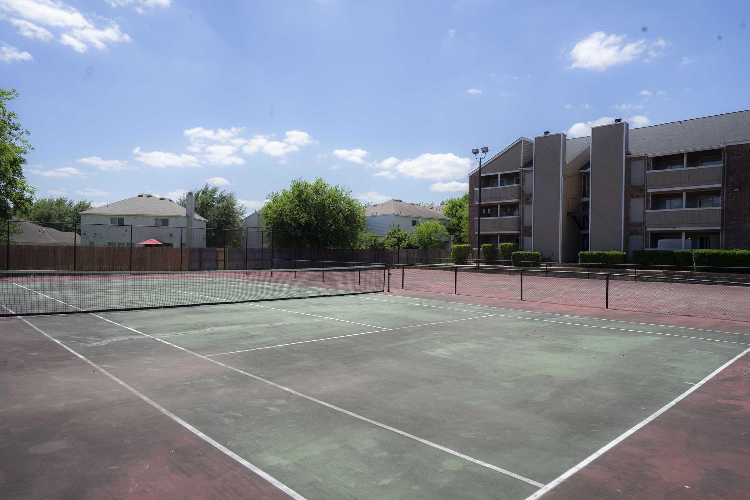 a basketball on a court with a racket