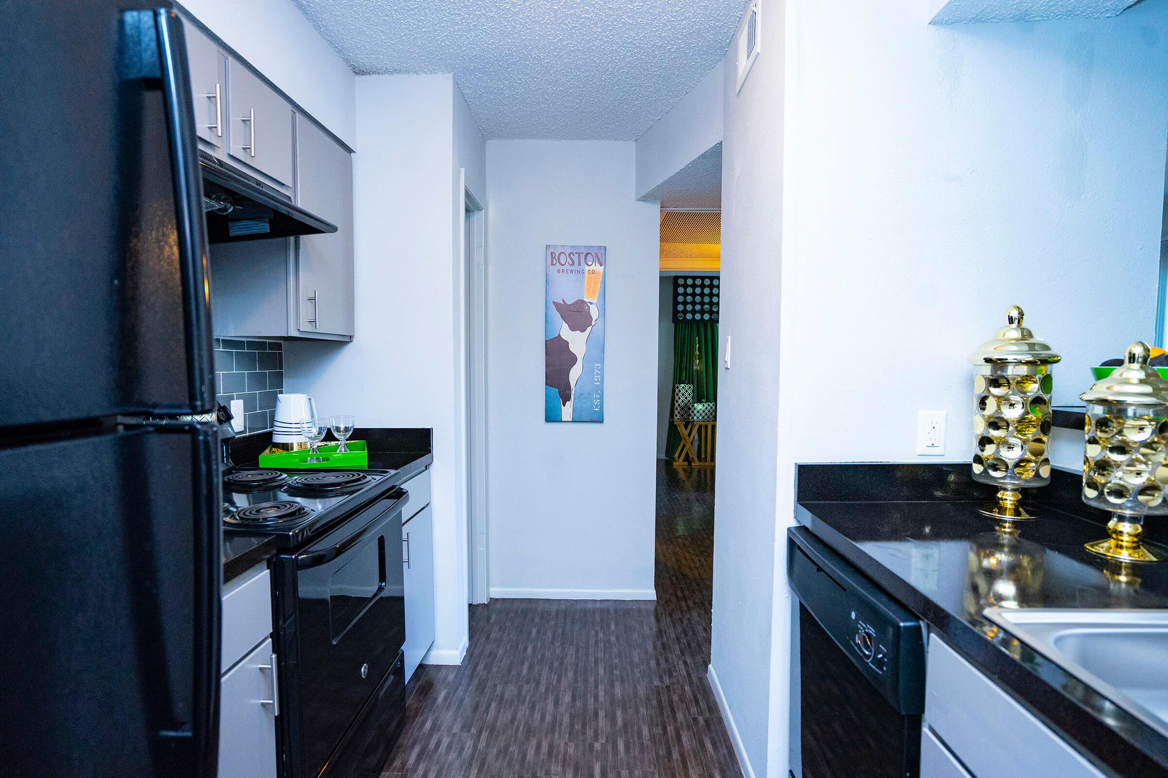 a kitchen with a sink and a refrigerator