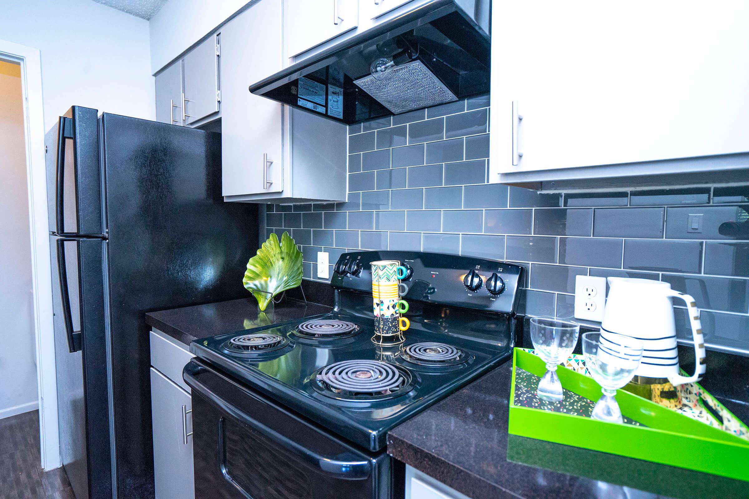 a stove top oven sitting inside of a kitchen