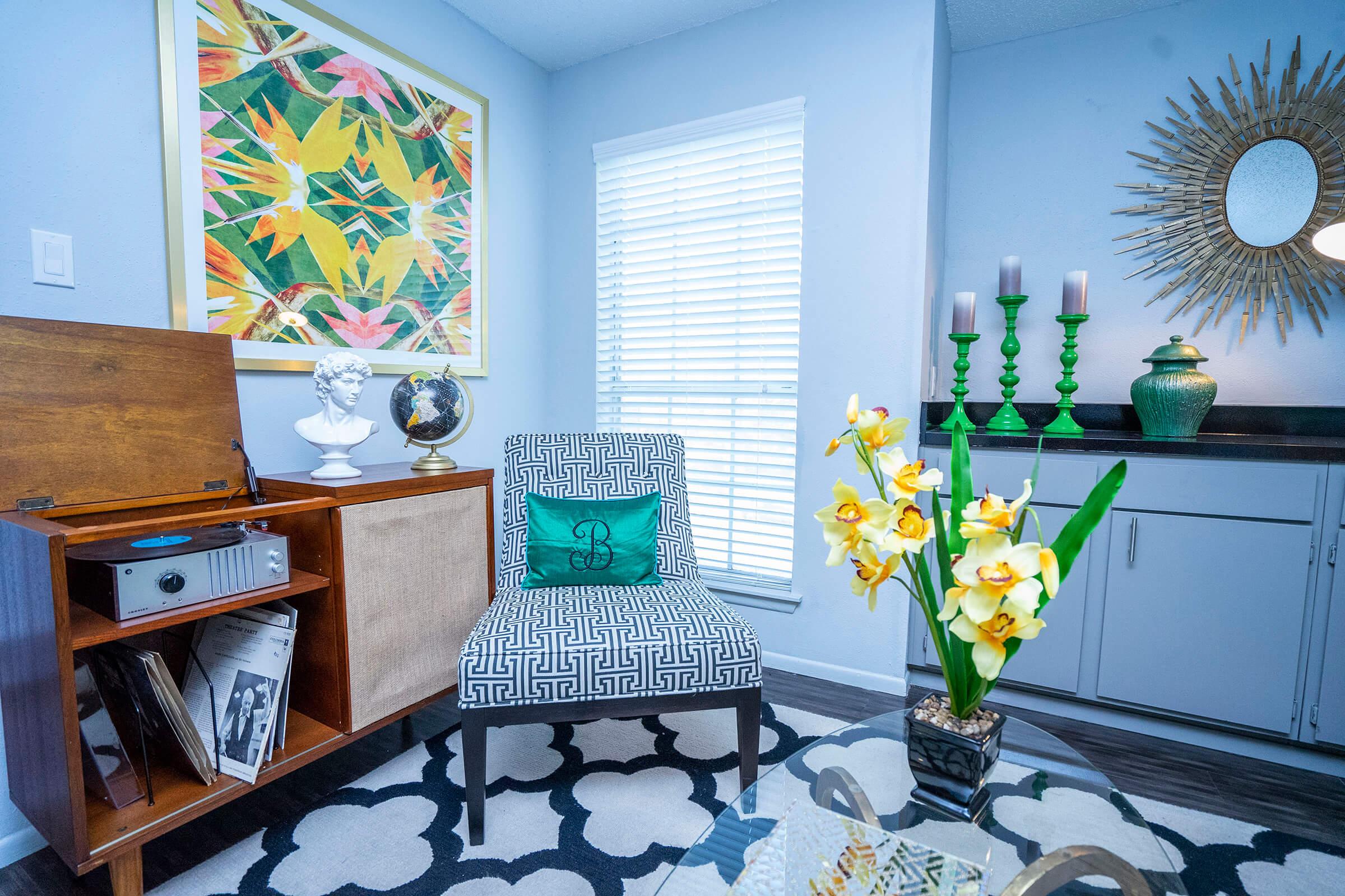 a room filled with furniture and vase of flowers on a table