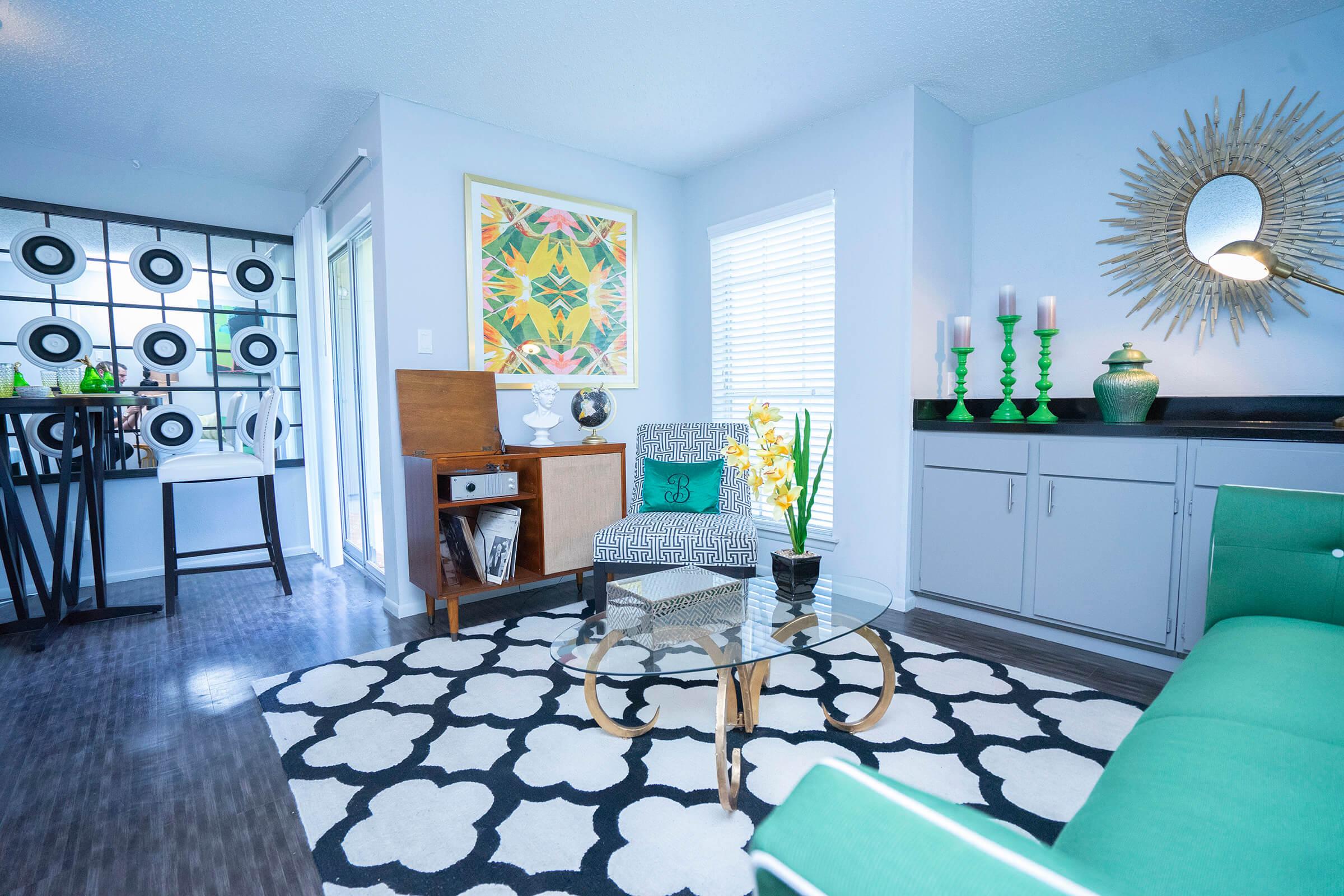 a living room filled with furniture and a large window