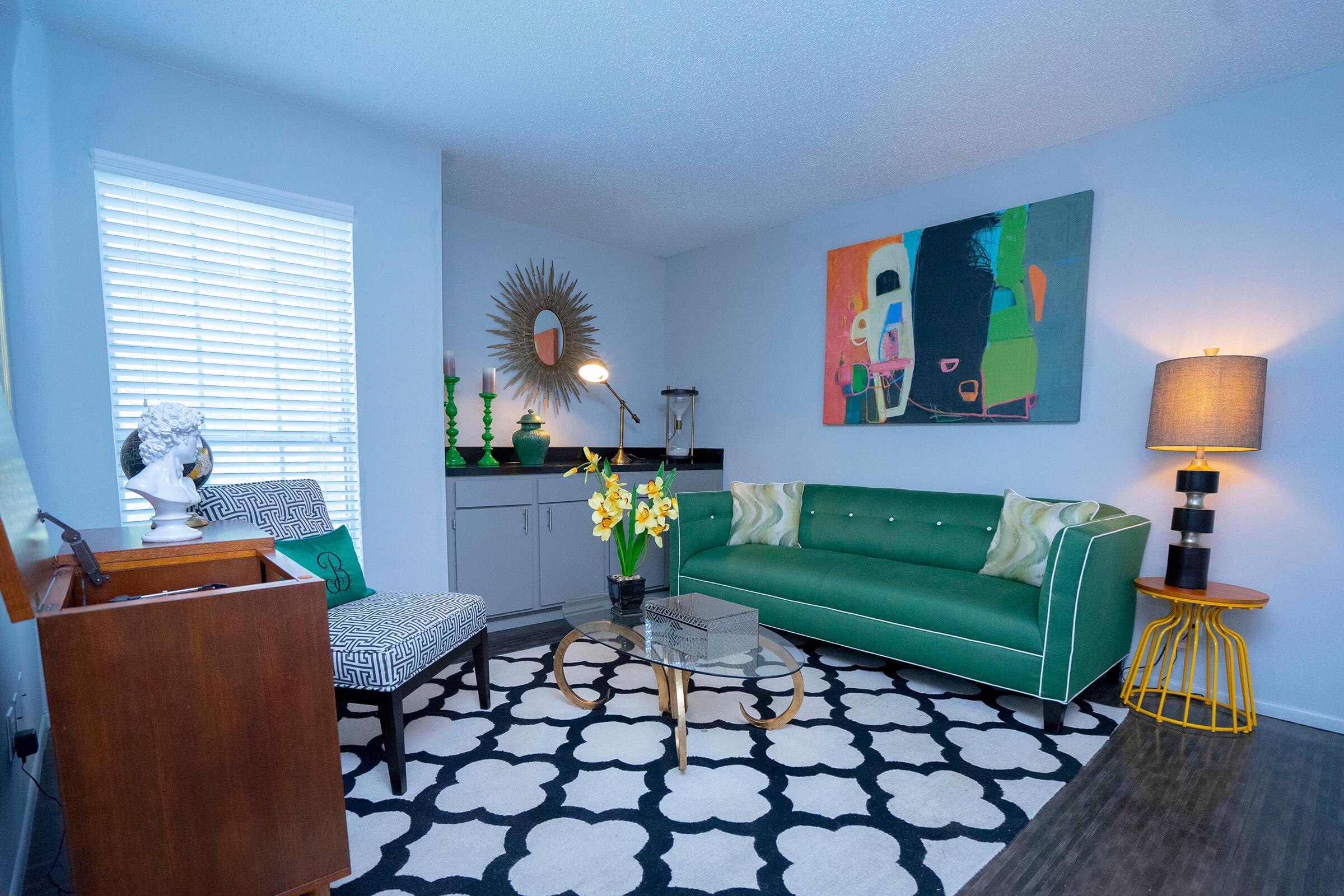 a living room filled with furniture and a large window