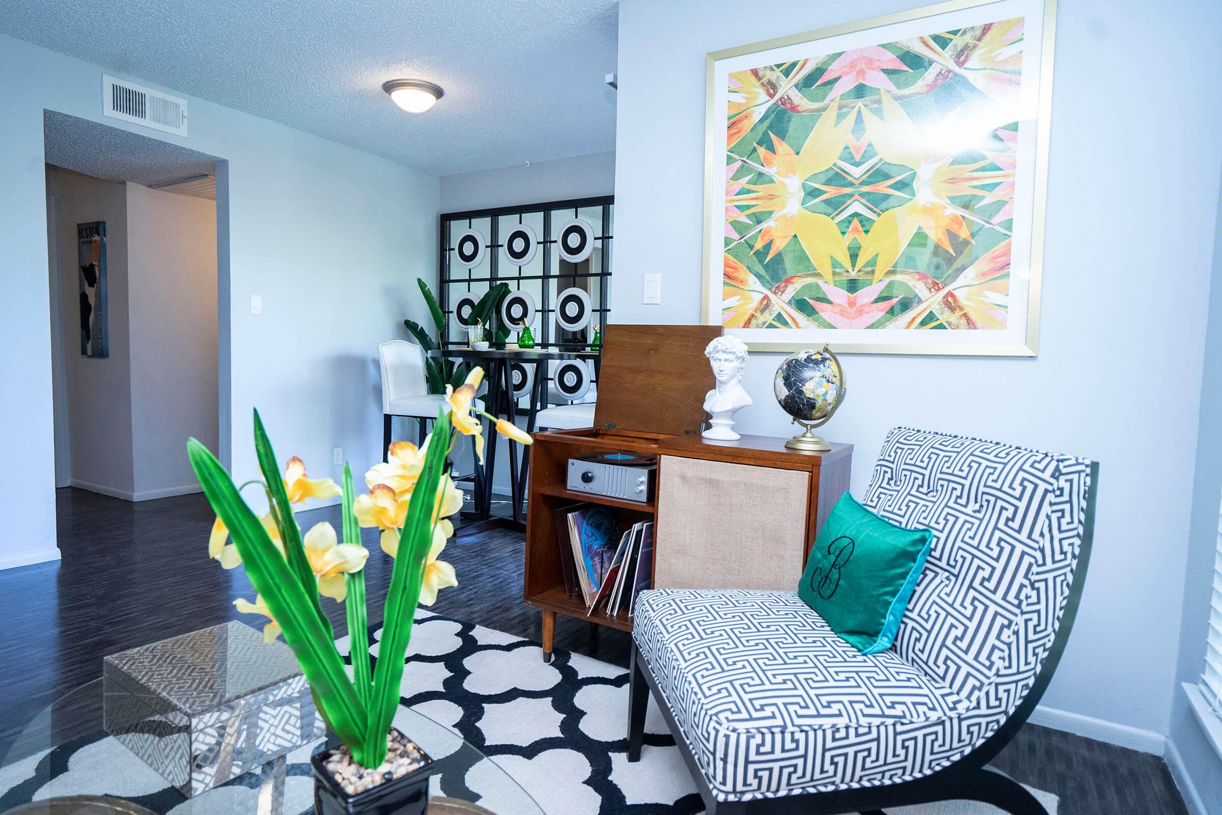 a room filled with furniture and vase of flowers on a table