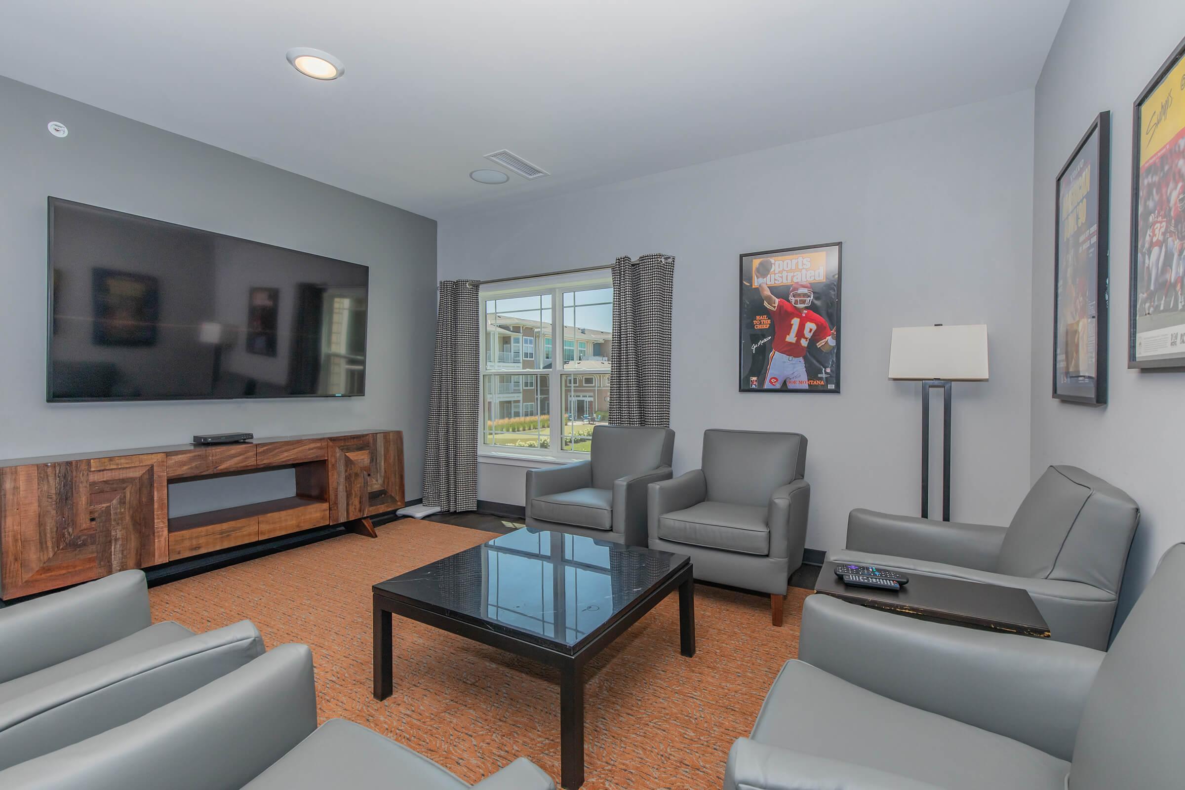 a living room filled with furniture and a flat screen tv