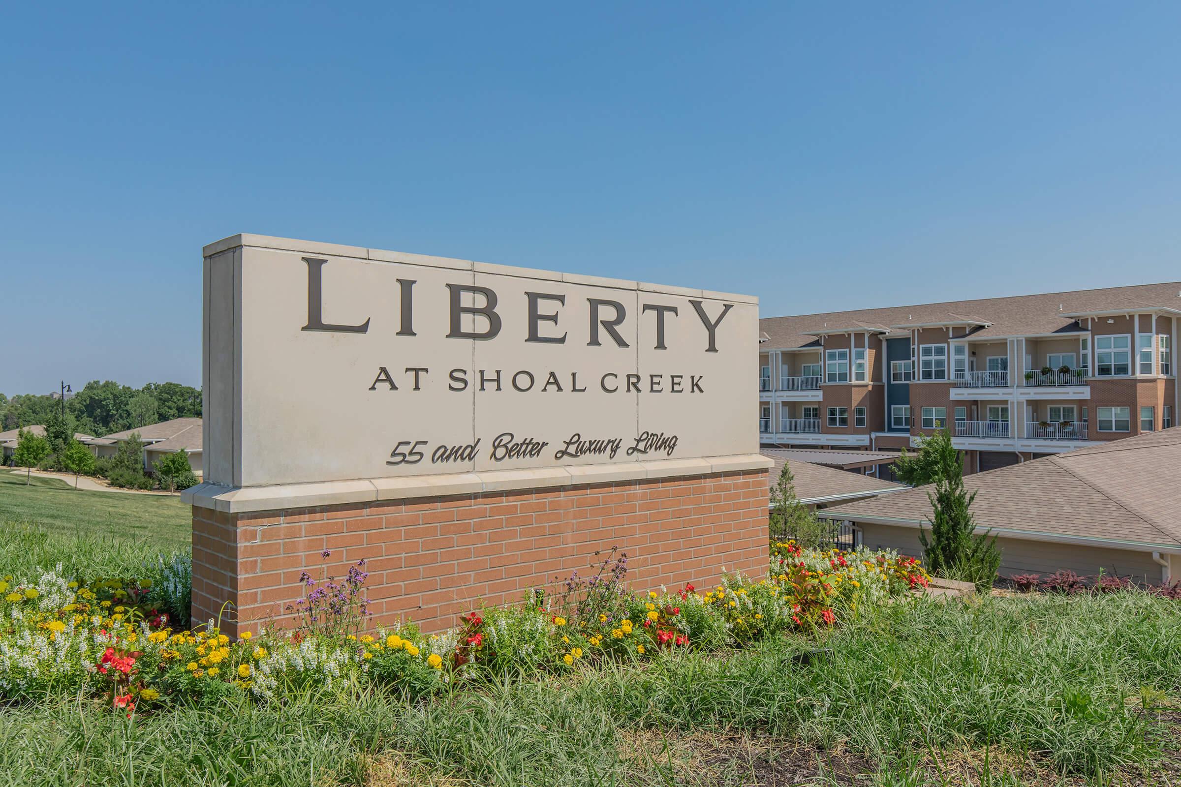 a sign in front of a brick building