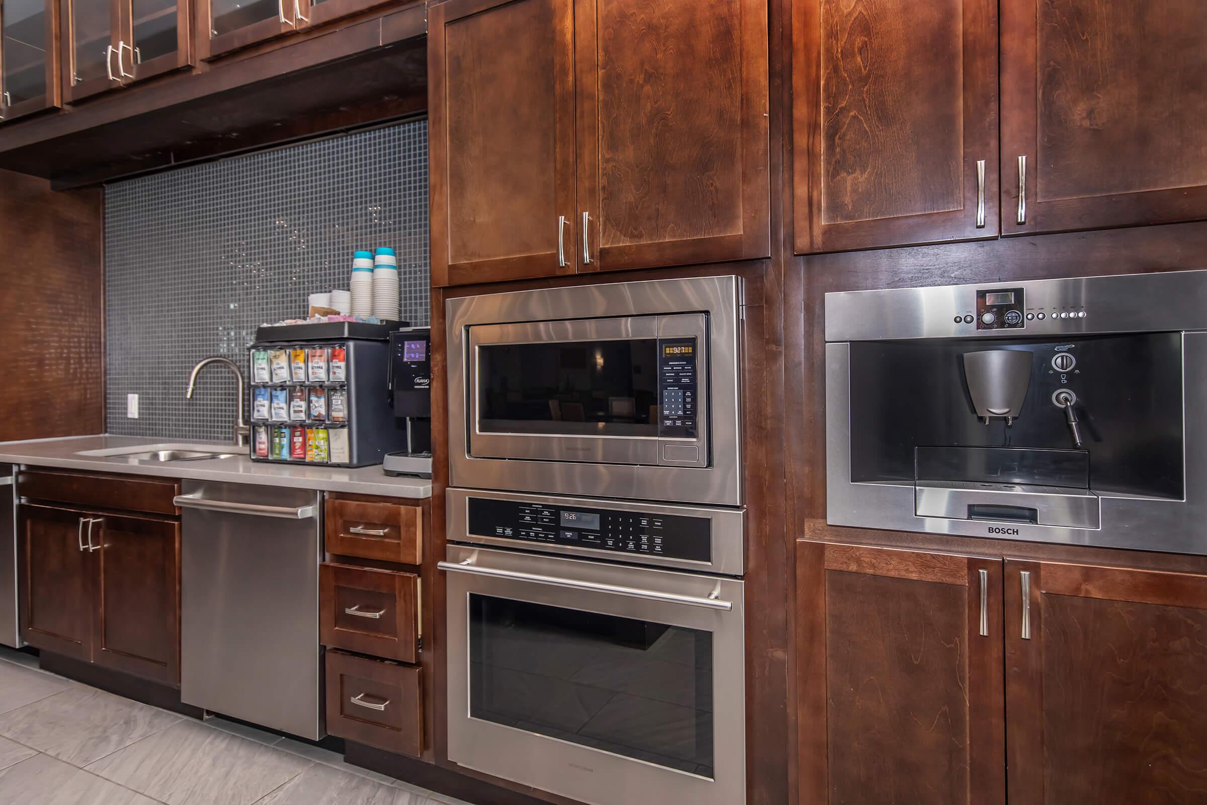 a kitchen with stainless steel appliances and wooden cabinets