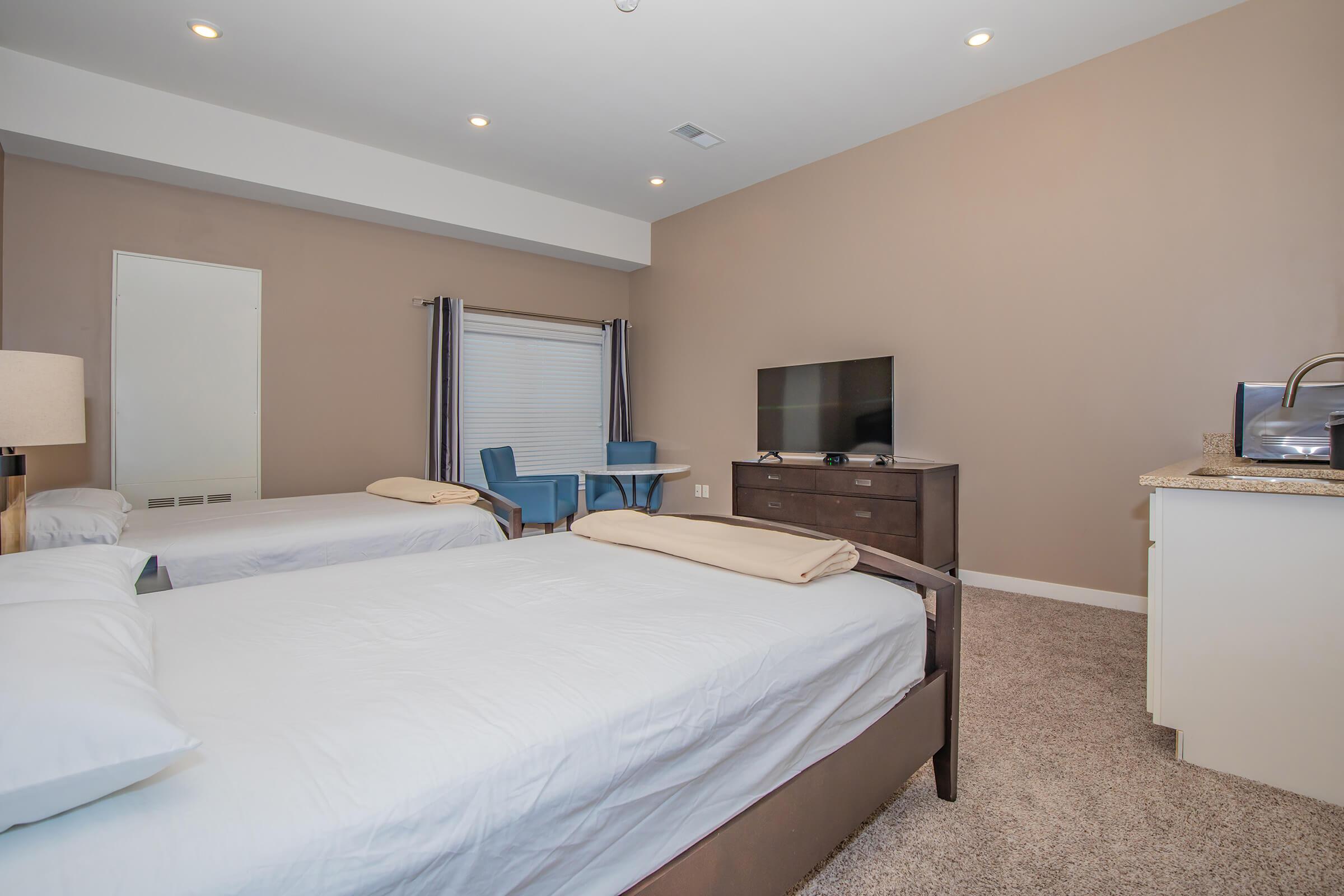 a bedroom with a large bed in a hotel room