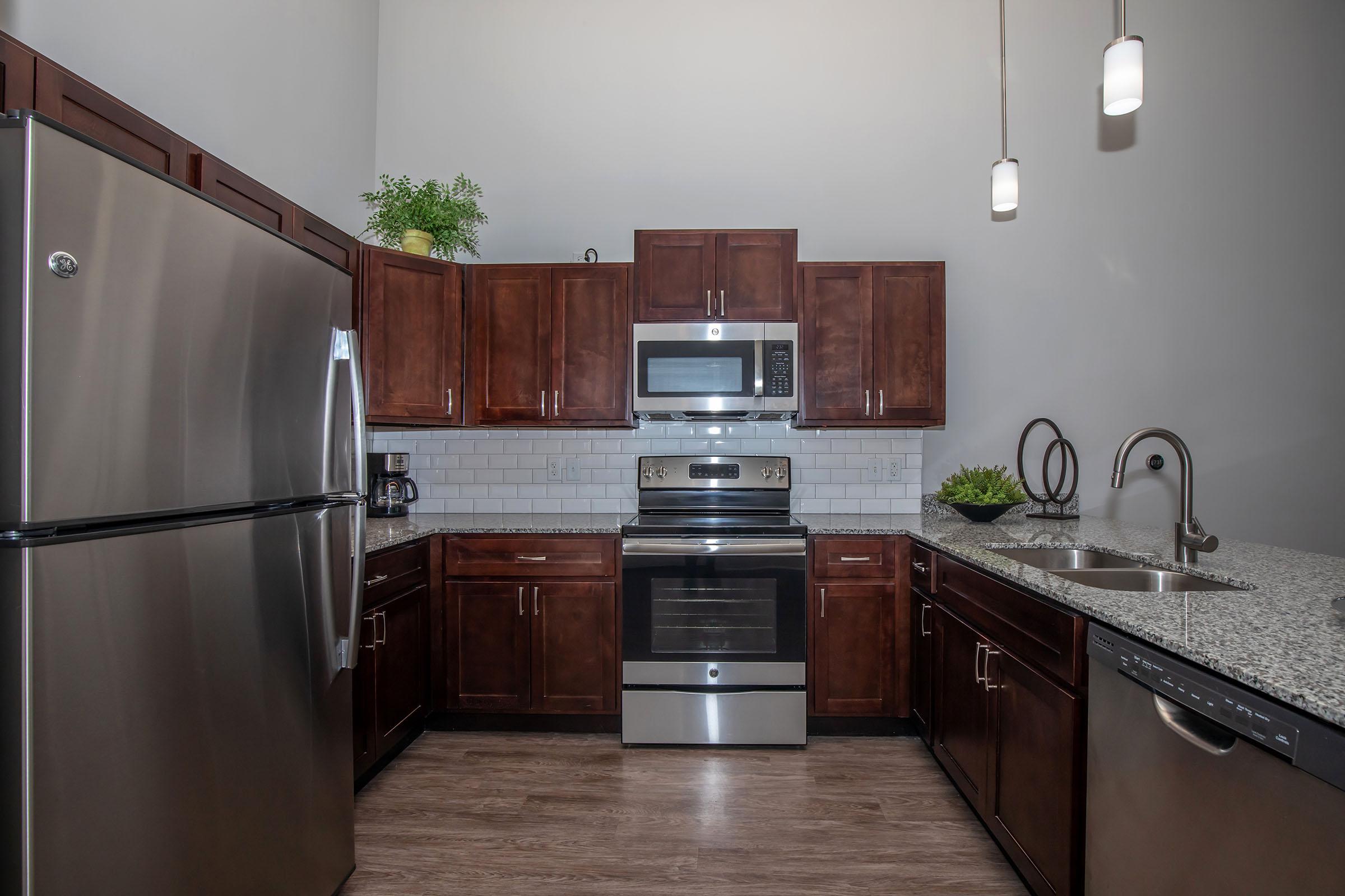 a kitchen with stainless steel appliances and wooden cabinets