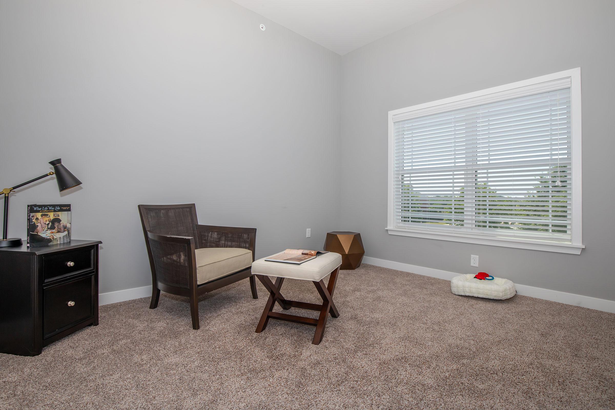 a living room filled with furniture and a large window