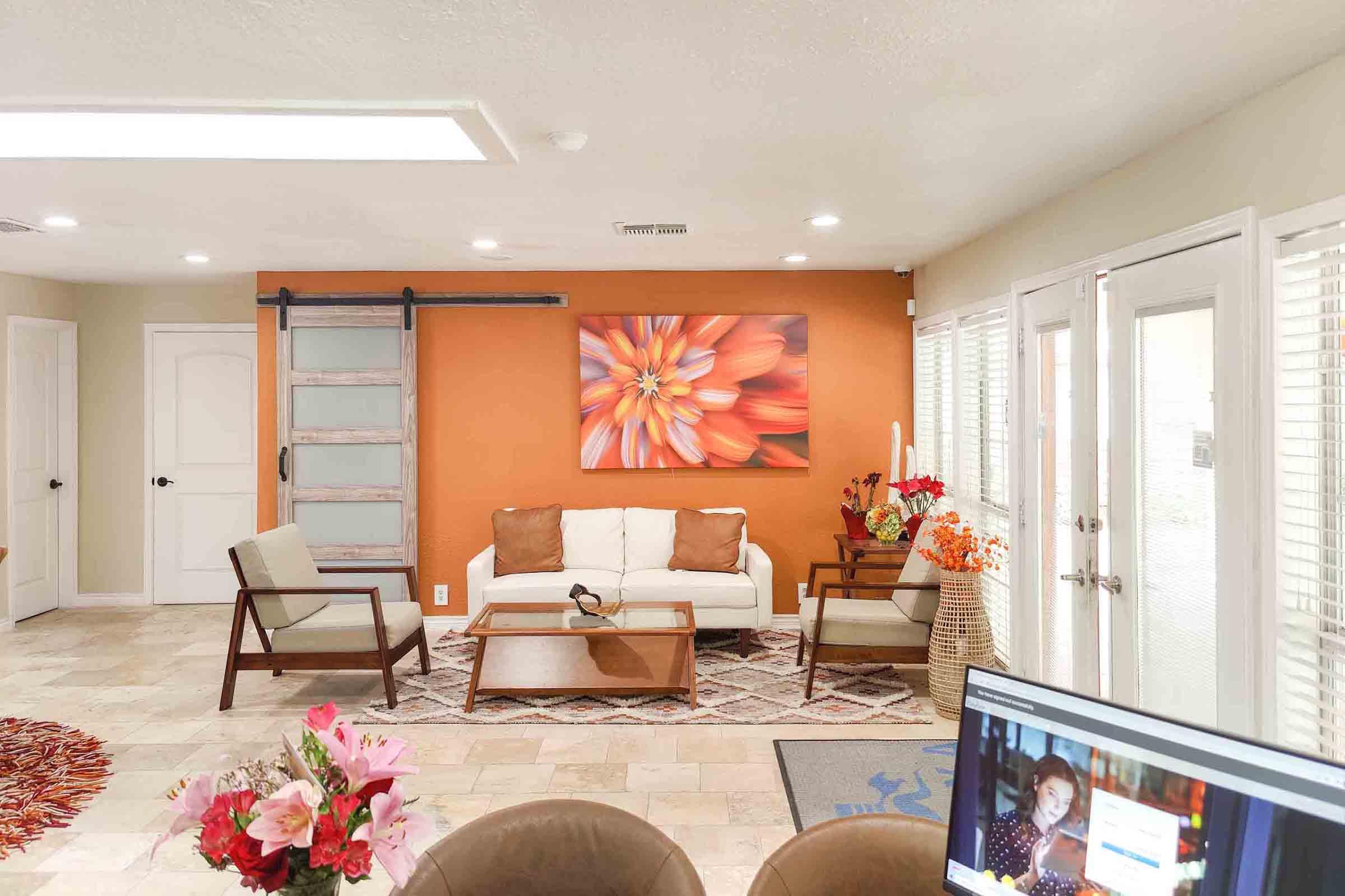 a living room filled with furniture and a flat screen tv