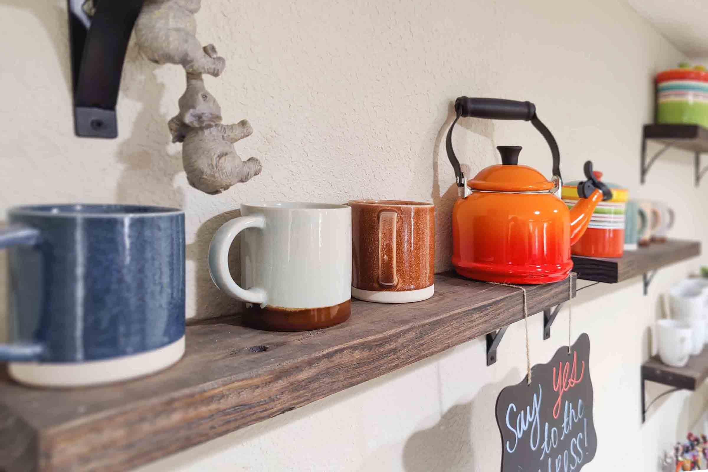 a kitchen with a sink and a cup of coffee