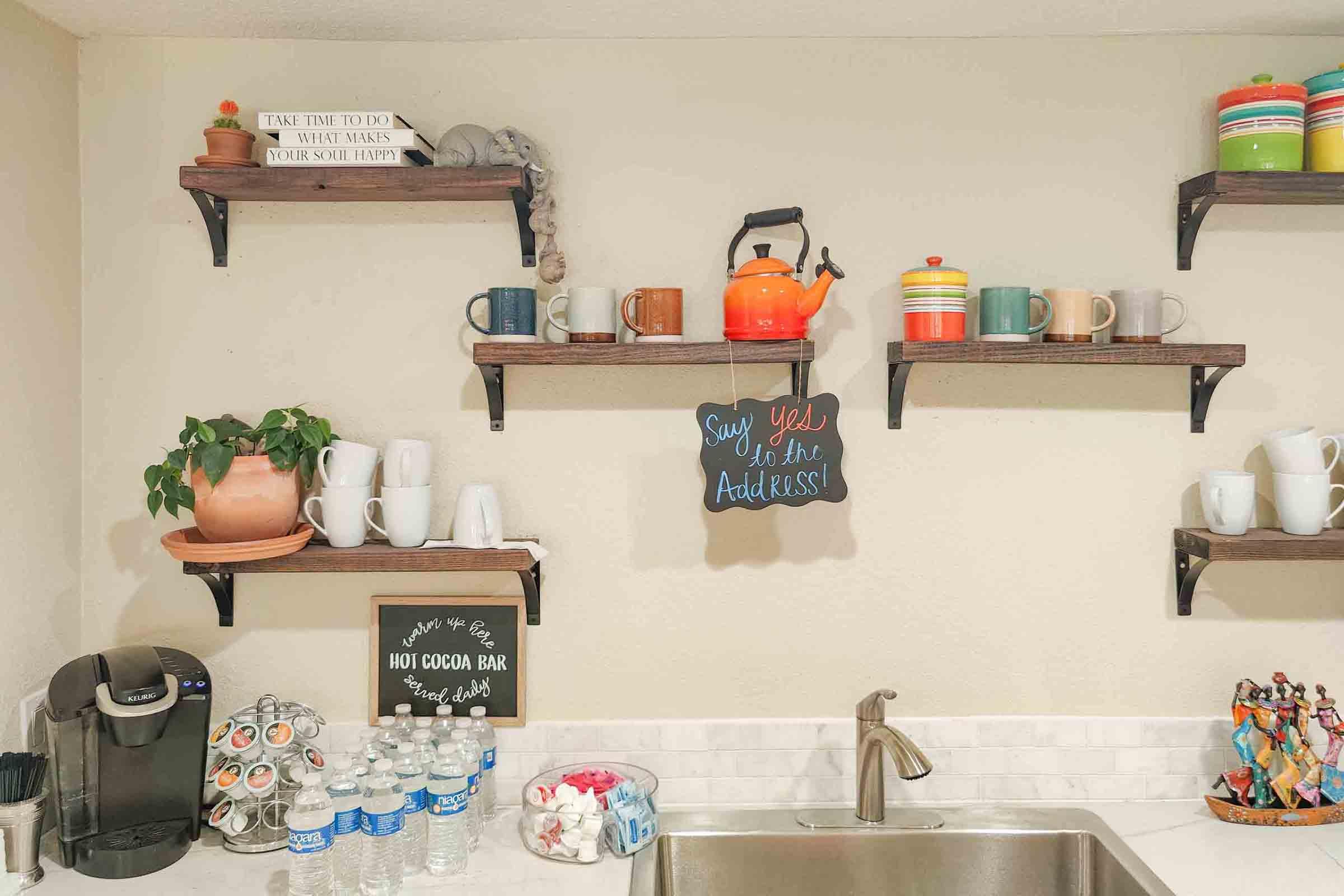 a kitchen with a sink and a mirror