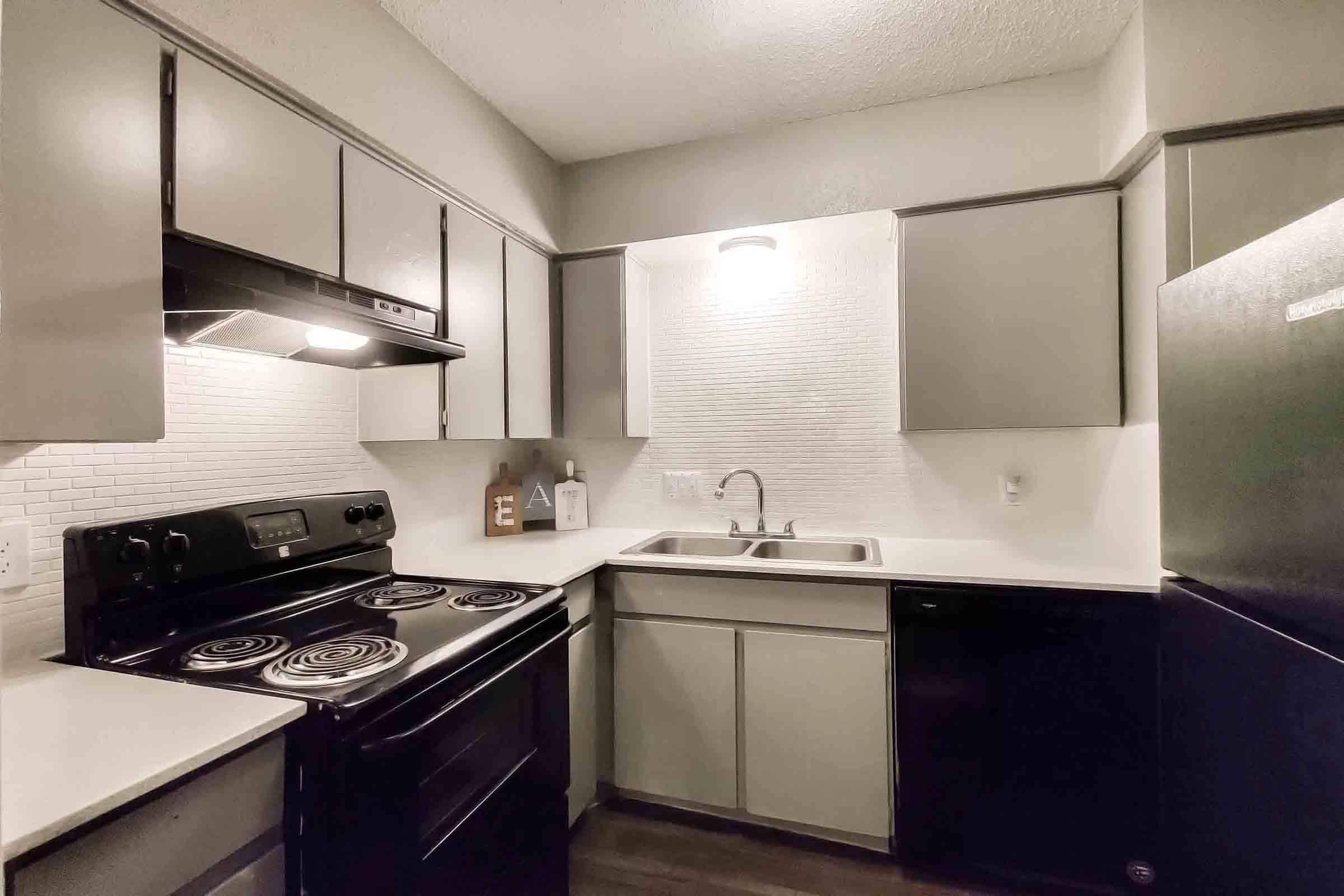 a stove top oven sitting inside of a kitchen