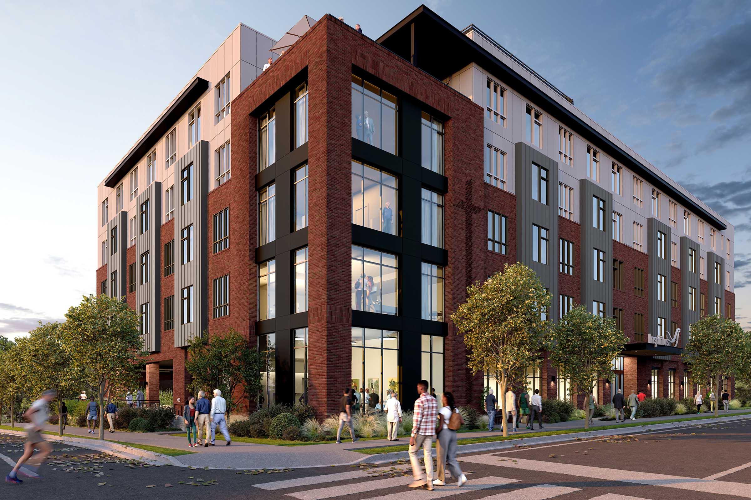 A modern multi-story building featuring a mix of brick and metal exteriors, large glass windows, and a contemporary design. The street in front is bustling with pedestrians. Lush landscaping with trees and shrubs complements the urban setting. The scene is set during the day with a clear sky.