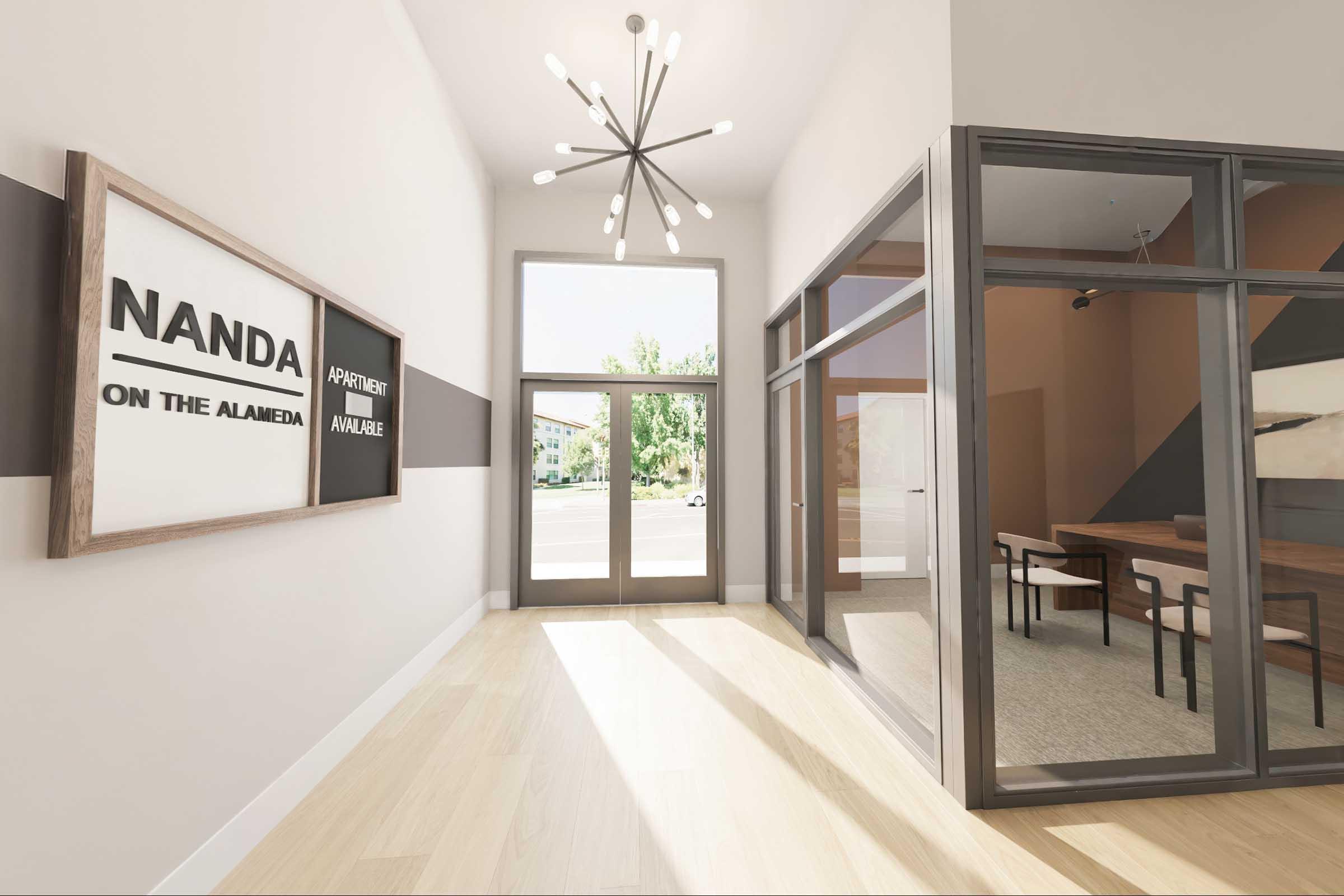 Modern lobby of a building featuring large windows, stylish light fixtures, and a combination of framed signs. The space includes a glass conference room with a wooden table, vibrant wall colors, and contemporary flooring, creating a welcoming and professional atmosphere.