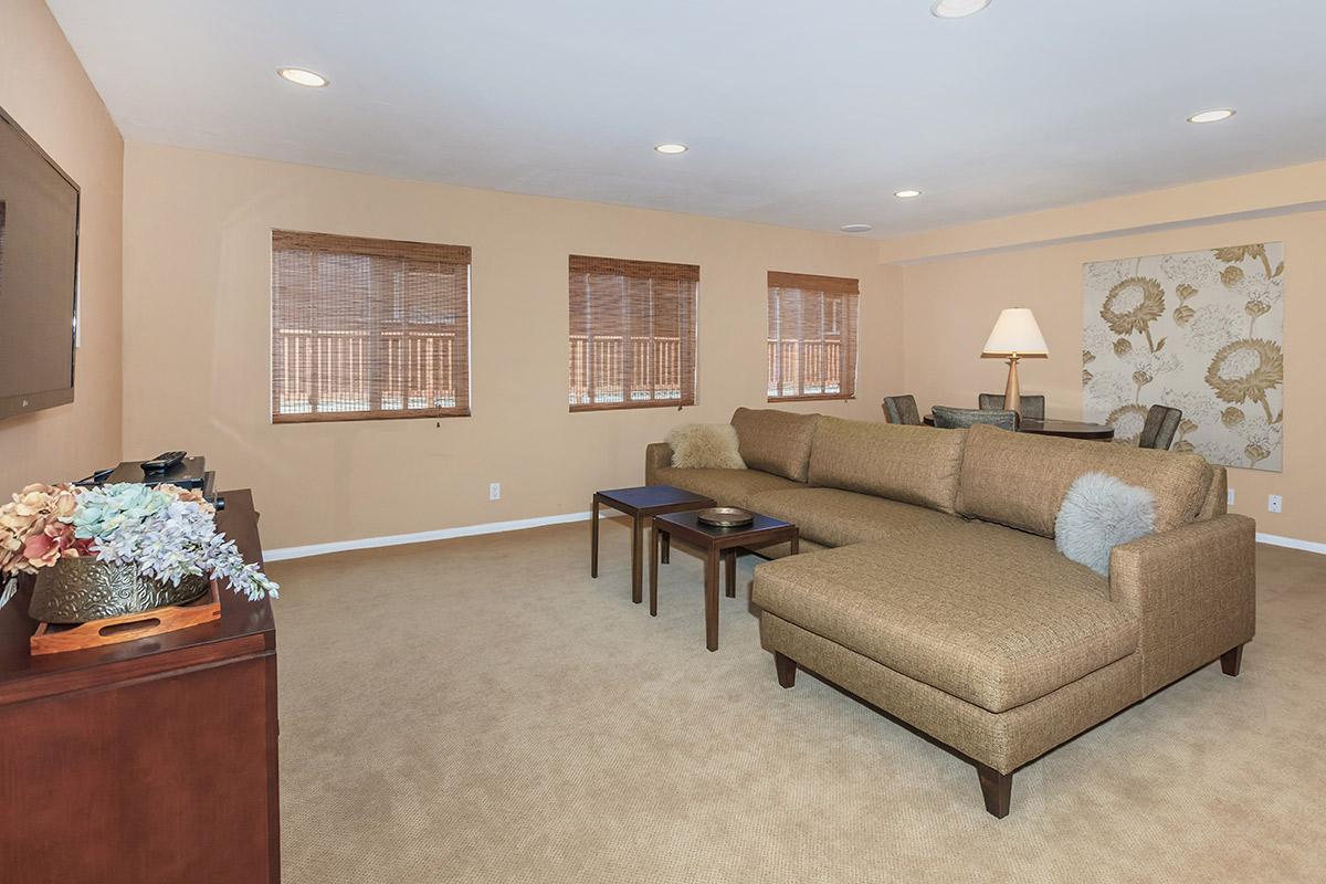 a living room filled with furniture and a flat screen tv