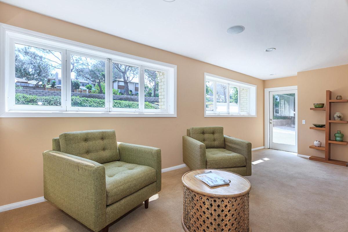 a living room filled with furniture and a large window