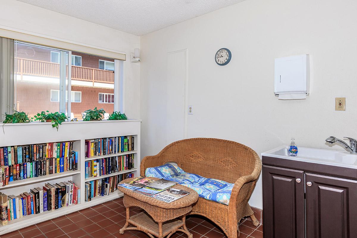 a living room filled with furniture and a book shelf