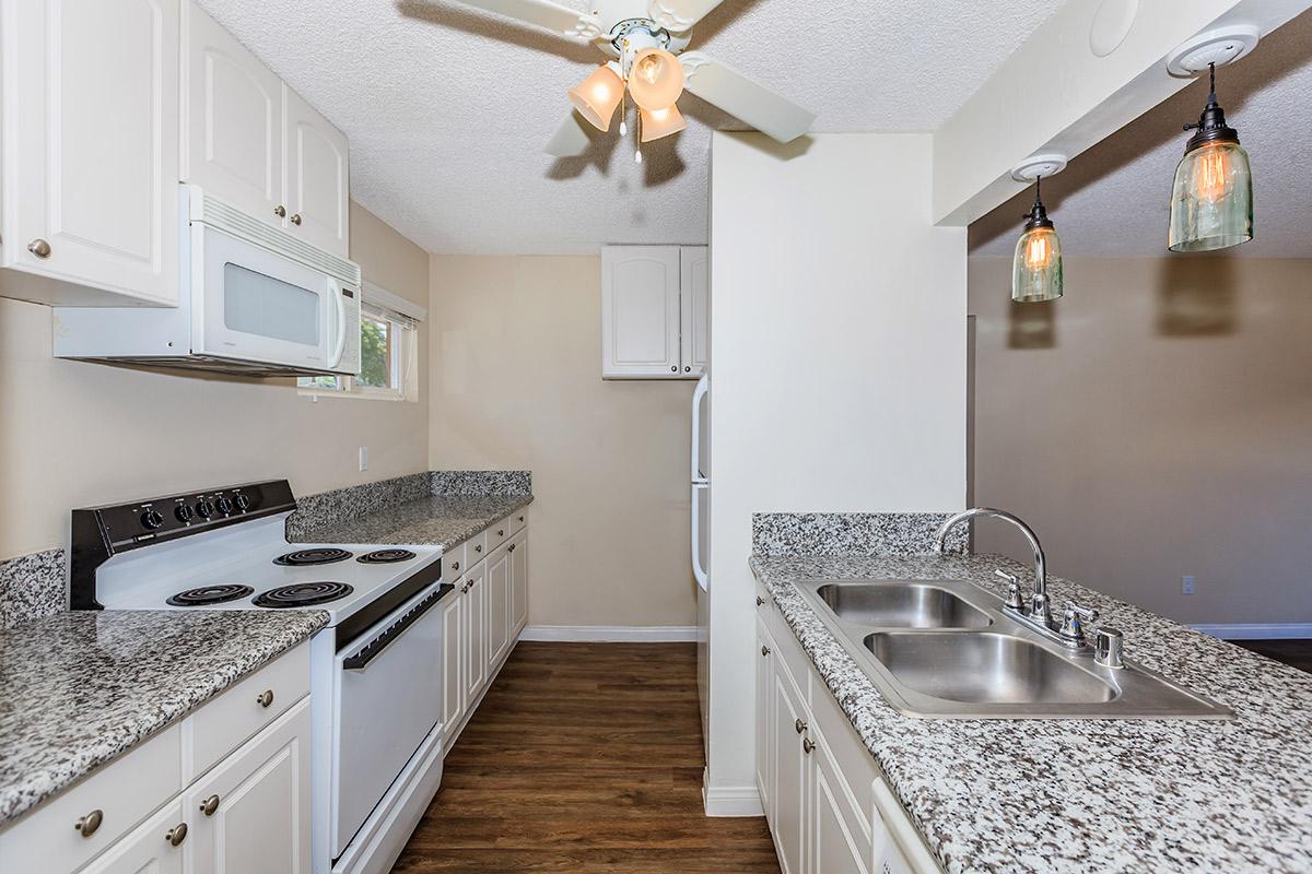 a kitchen with a stove and a sink