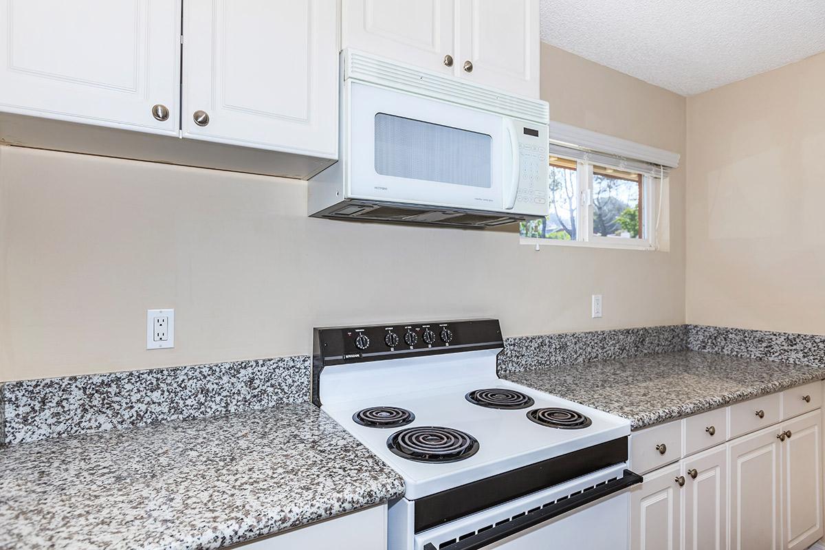 a kitchen with a stove and a sink