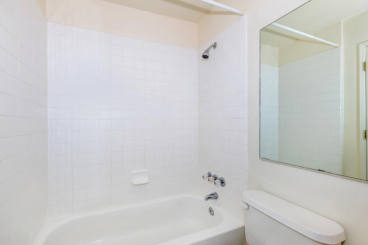 a white tub sitting next to a sink