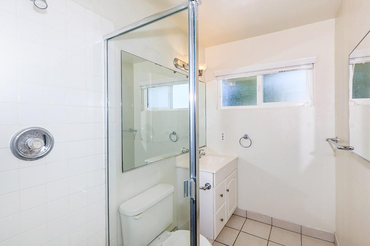 a white sink sitting under a window