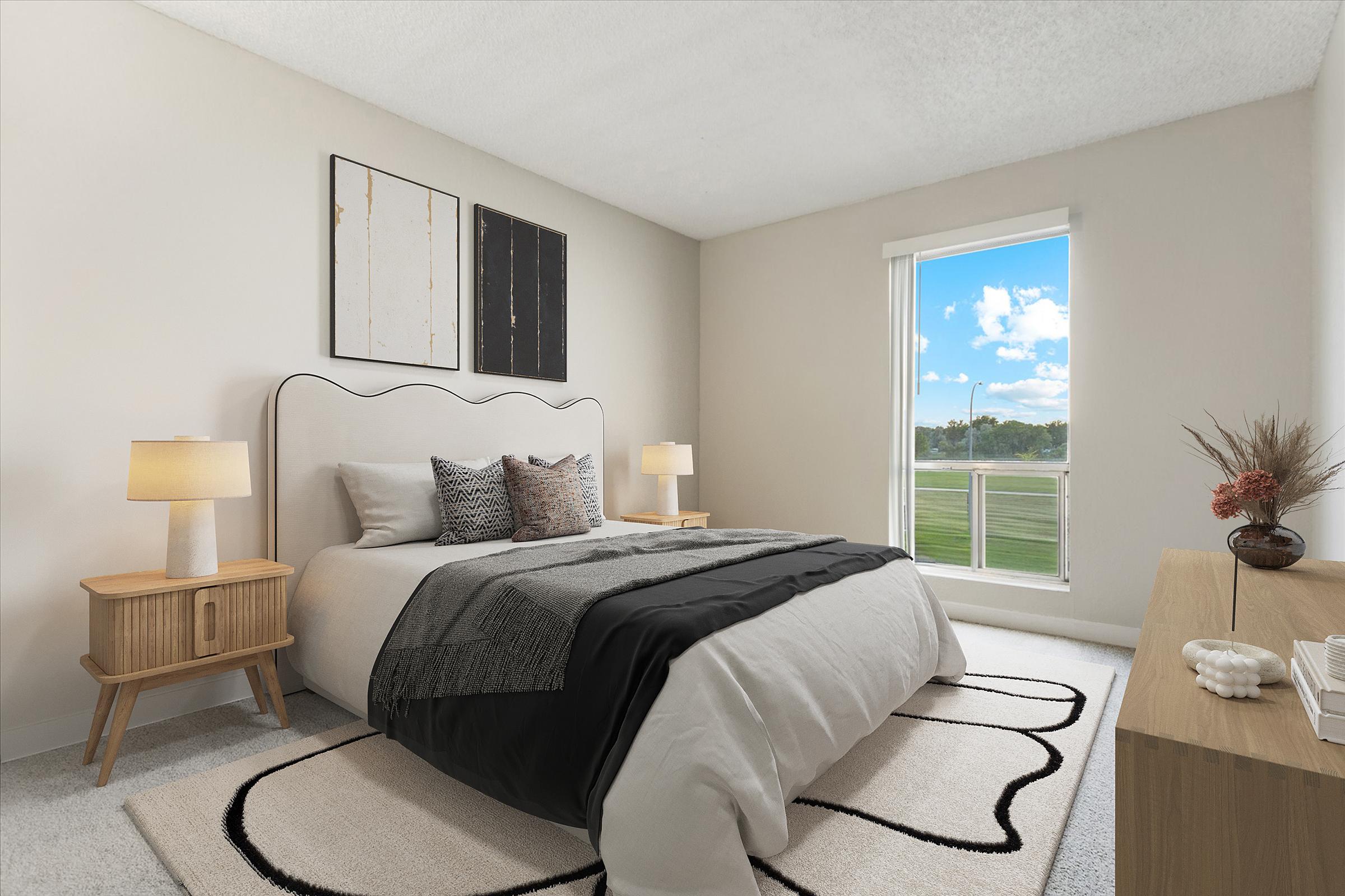 A modern bedroom with a stylish bed featuring a curved headboard, two bedside lamps on wooden nightstands, and a light-colored rug. A large window lets in natural light, showcasing a view of greenery outside. The walls are painted a soft, neutral color, and there are minimalist decorations.