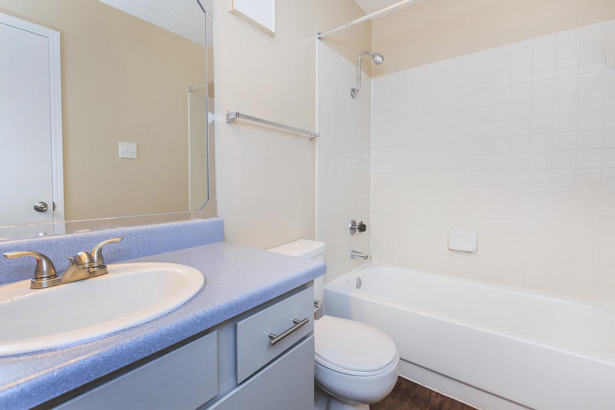 a large white tub sitting next to a sink