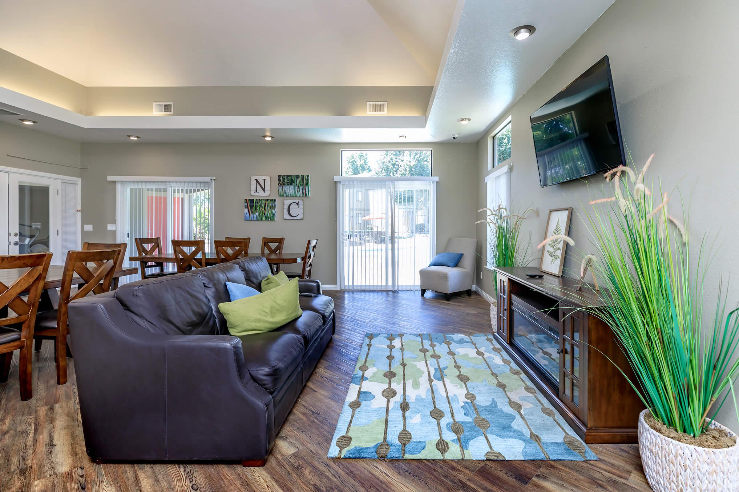 a living room filled with furniture and a large window