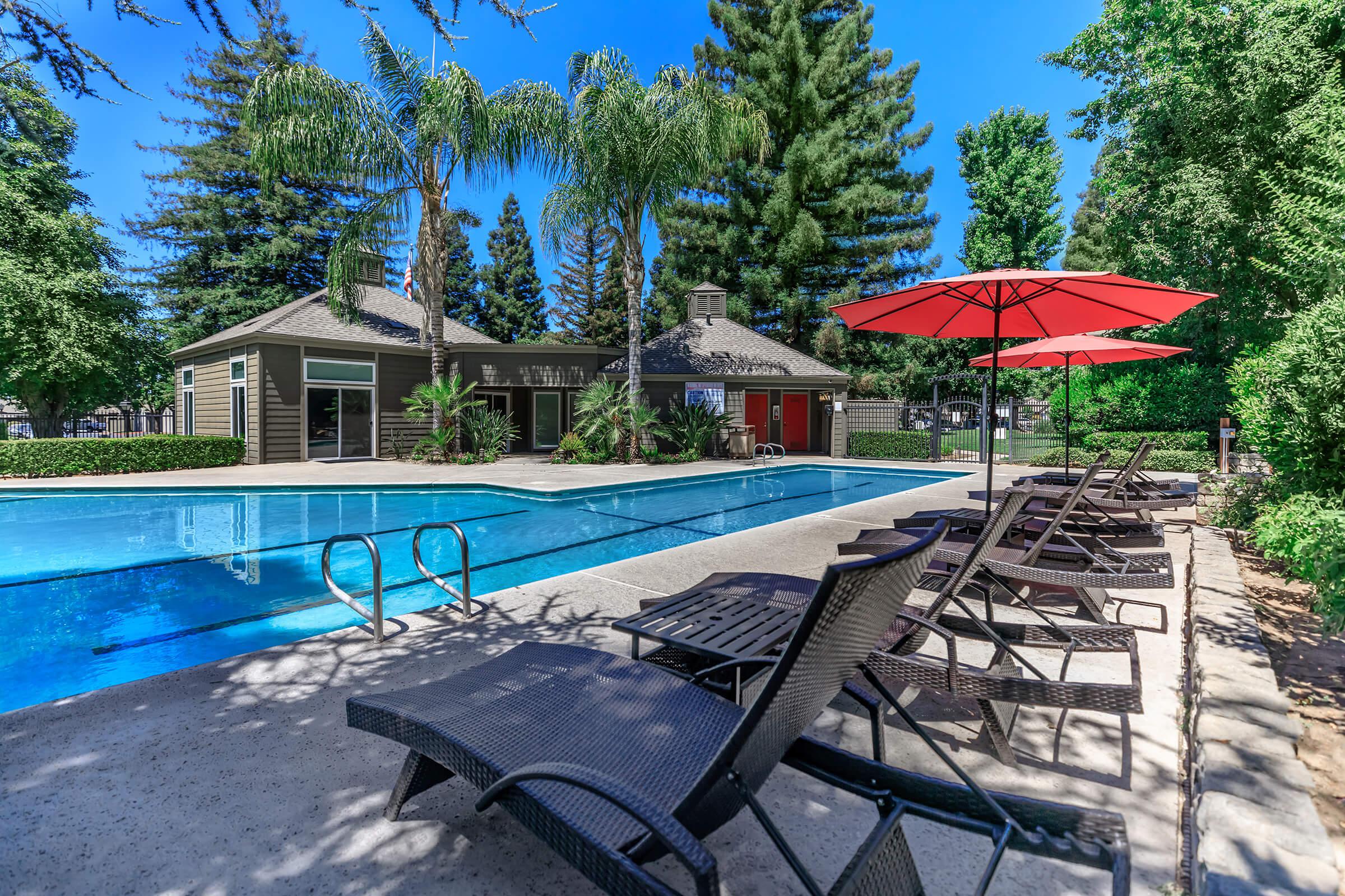 a group of lawn chairs sitting next to a pool