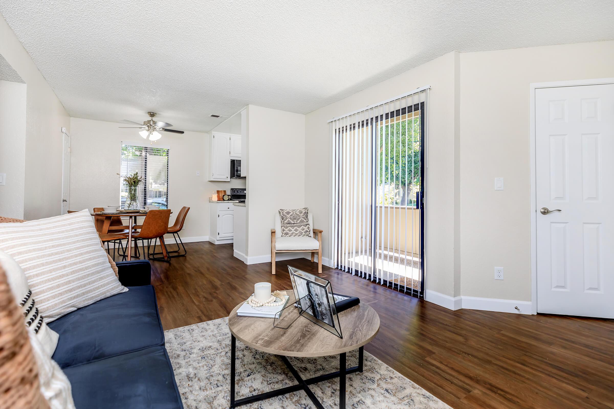 a living room filled with furniture on top of a wooden floor