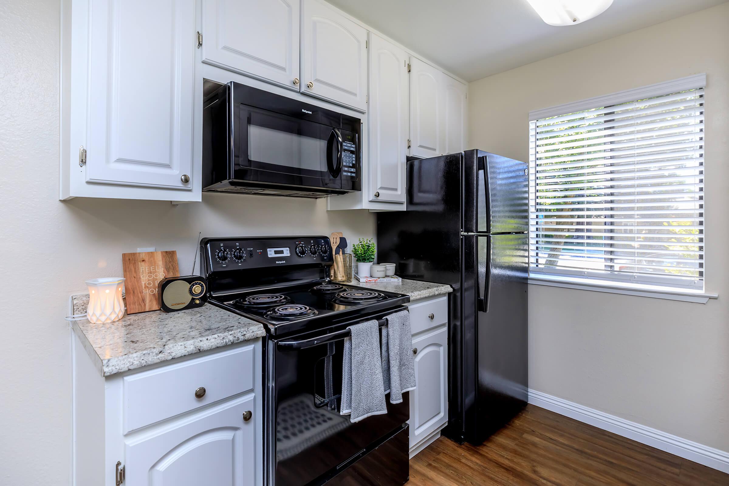 a stove top oven sitting inside of a kitchen