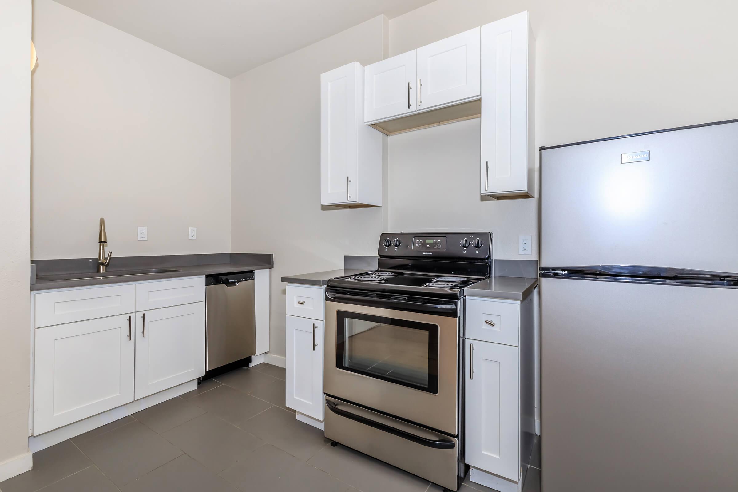 a stove top oven sitting inside of a kitchen