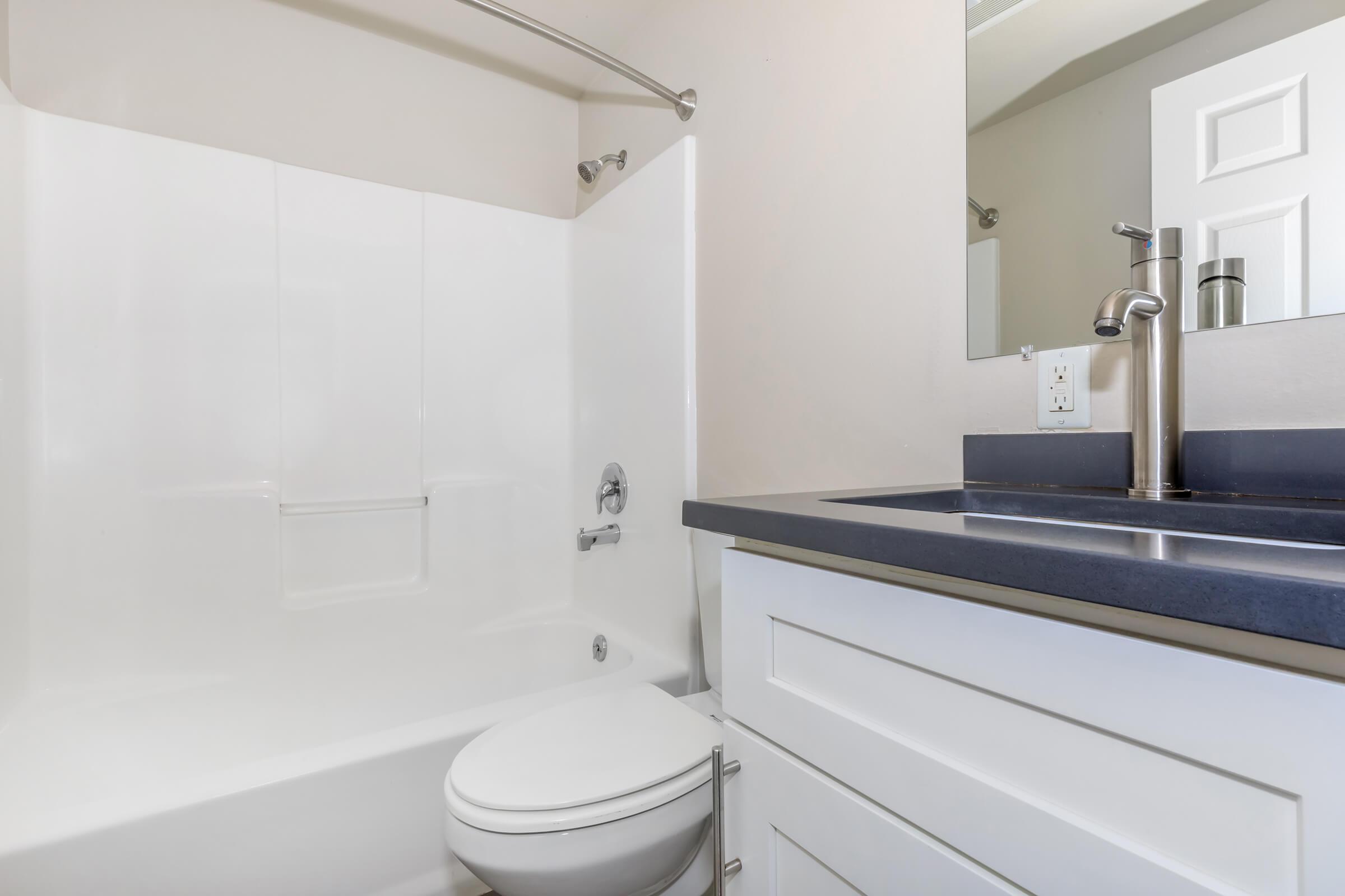 a room with a sink and a mirror