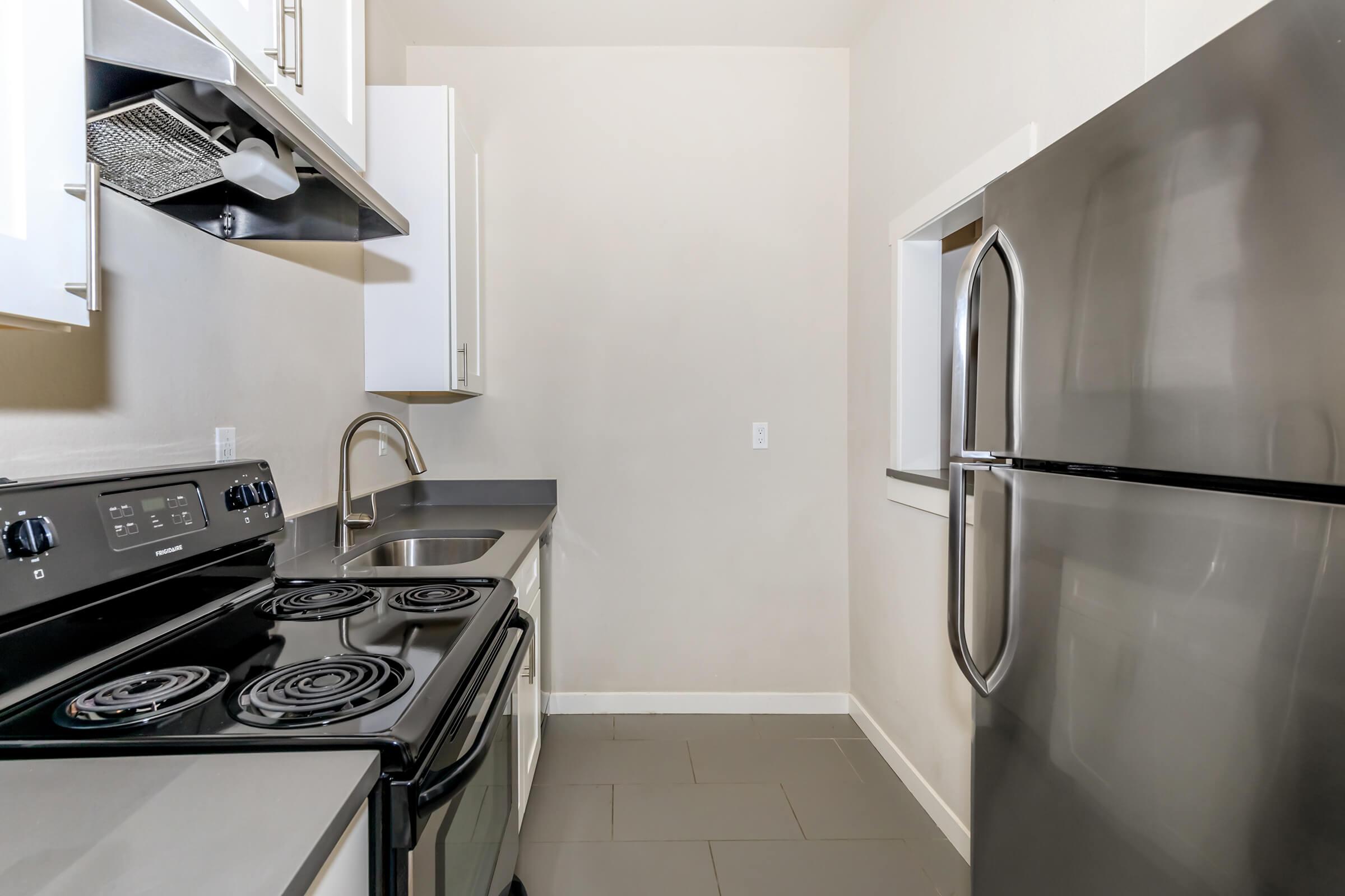 a stove top oven sitting inside of a kitchen
