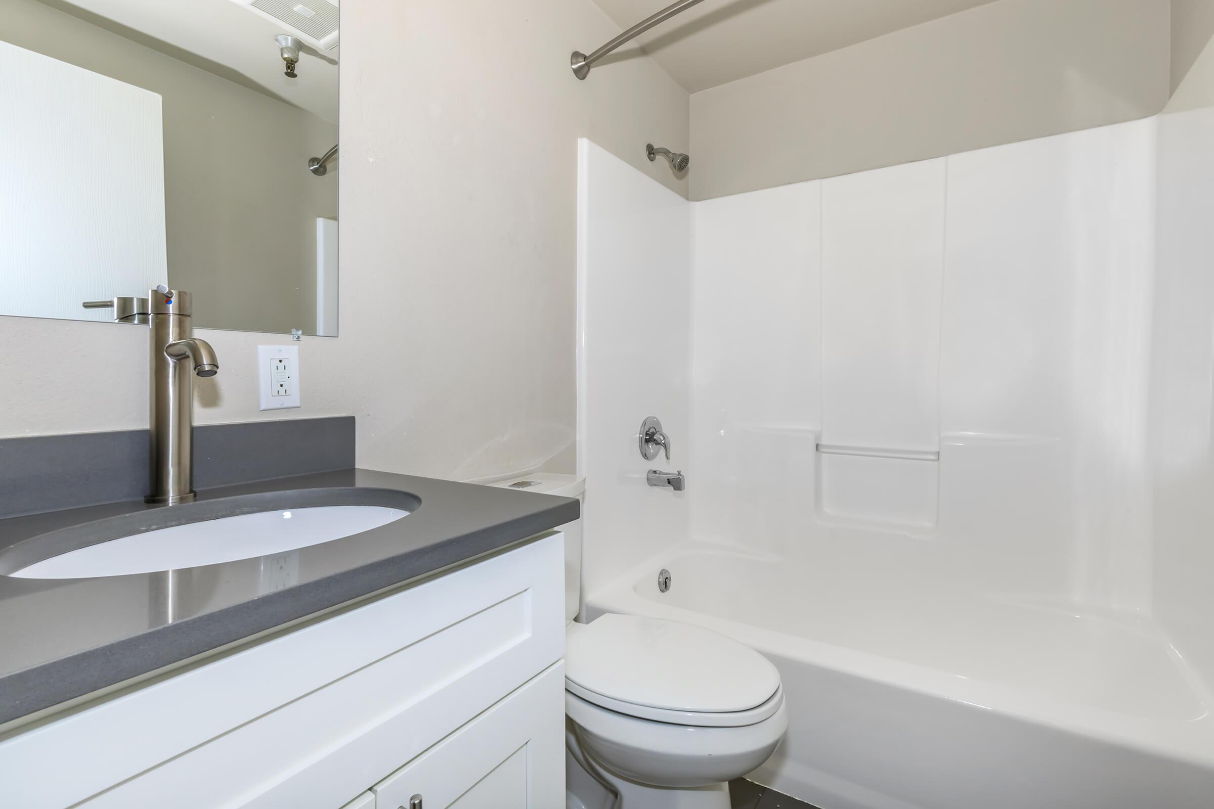 a room with a sink and a mirror