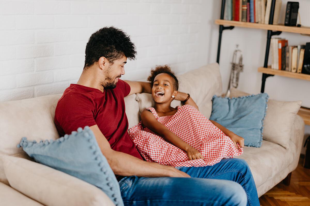 a man and a woman sitting on a bed