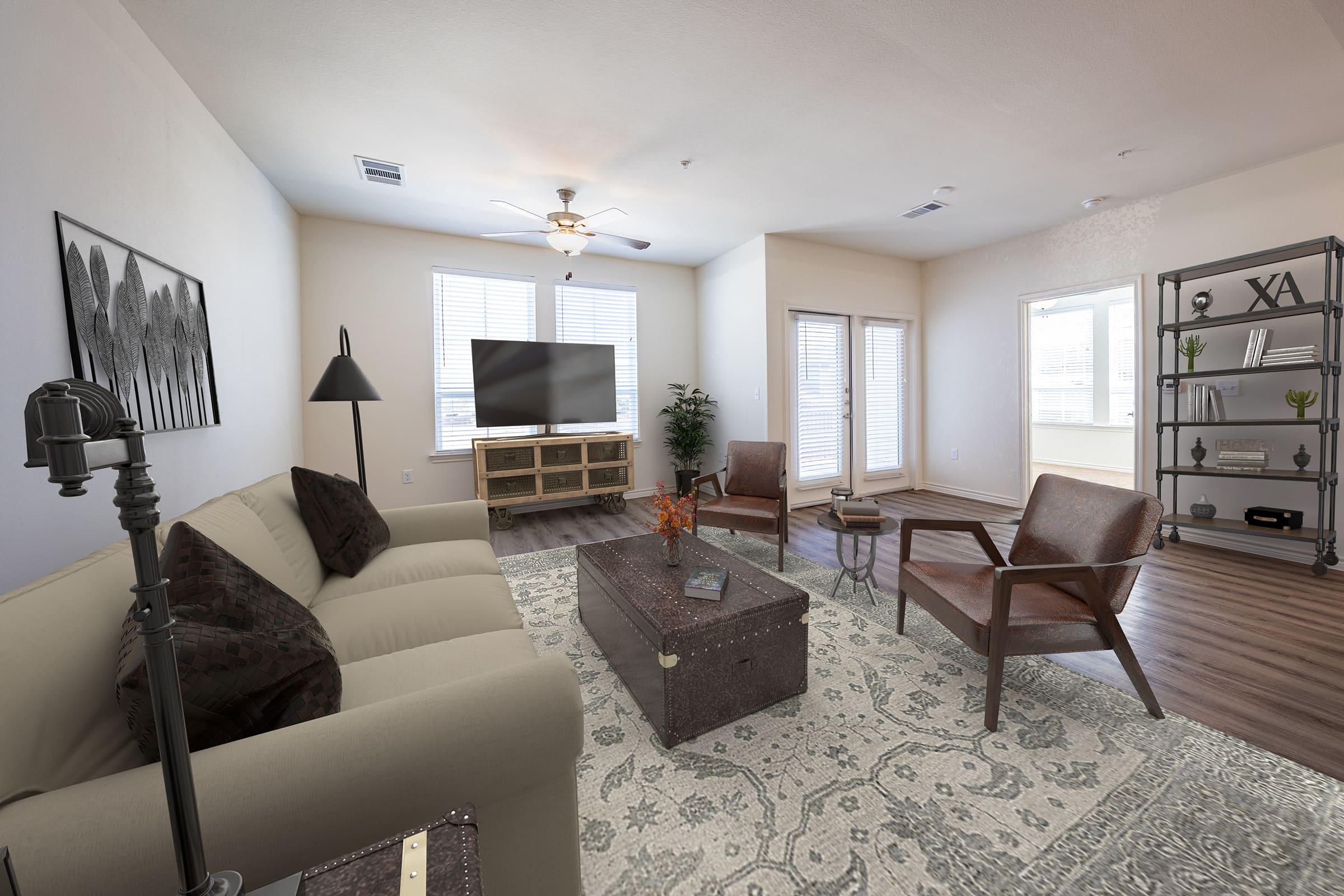 A modern living room featuring a light-colored sofa, two brown armchairs, and a coffee table. A large flat-screen TV sits on a stand against a wall. The room has large windows, allowing natural light, and a decorative plant in the corner. A stylish bookshelf with plants and decor is visible on one side.
