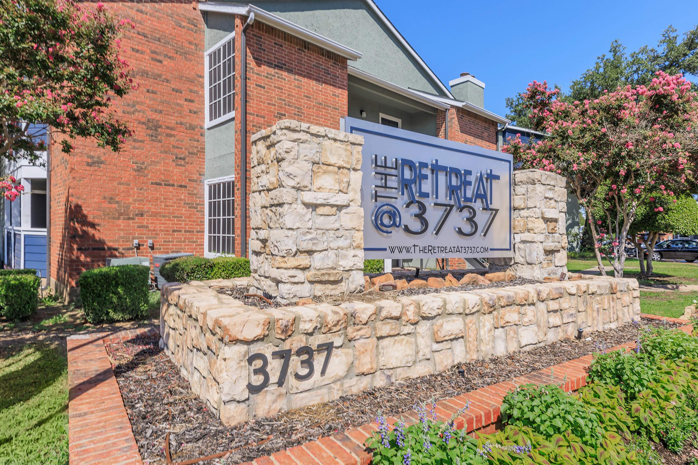 a sign in front of a brick building