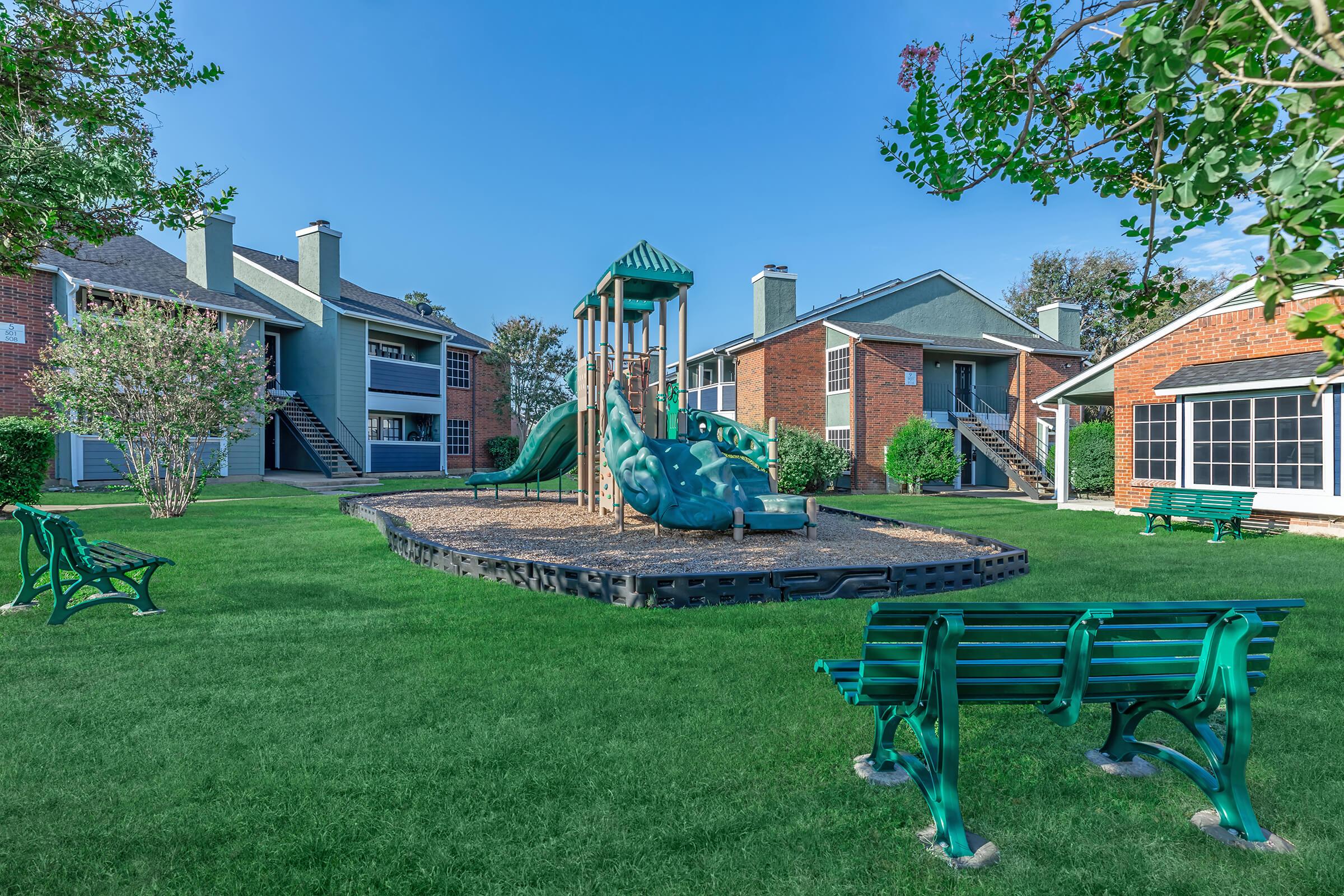 a couple of lawn chairs sitting on a bench in front of a house