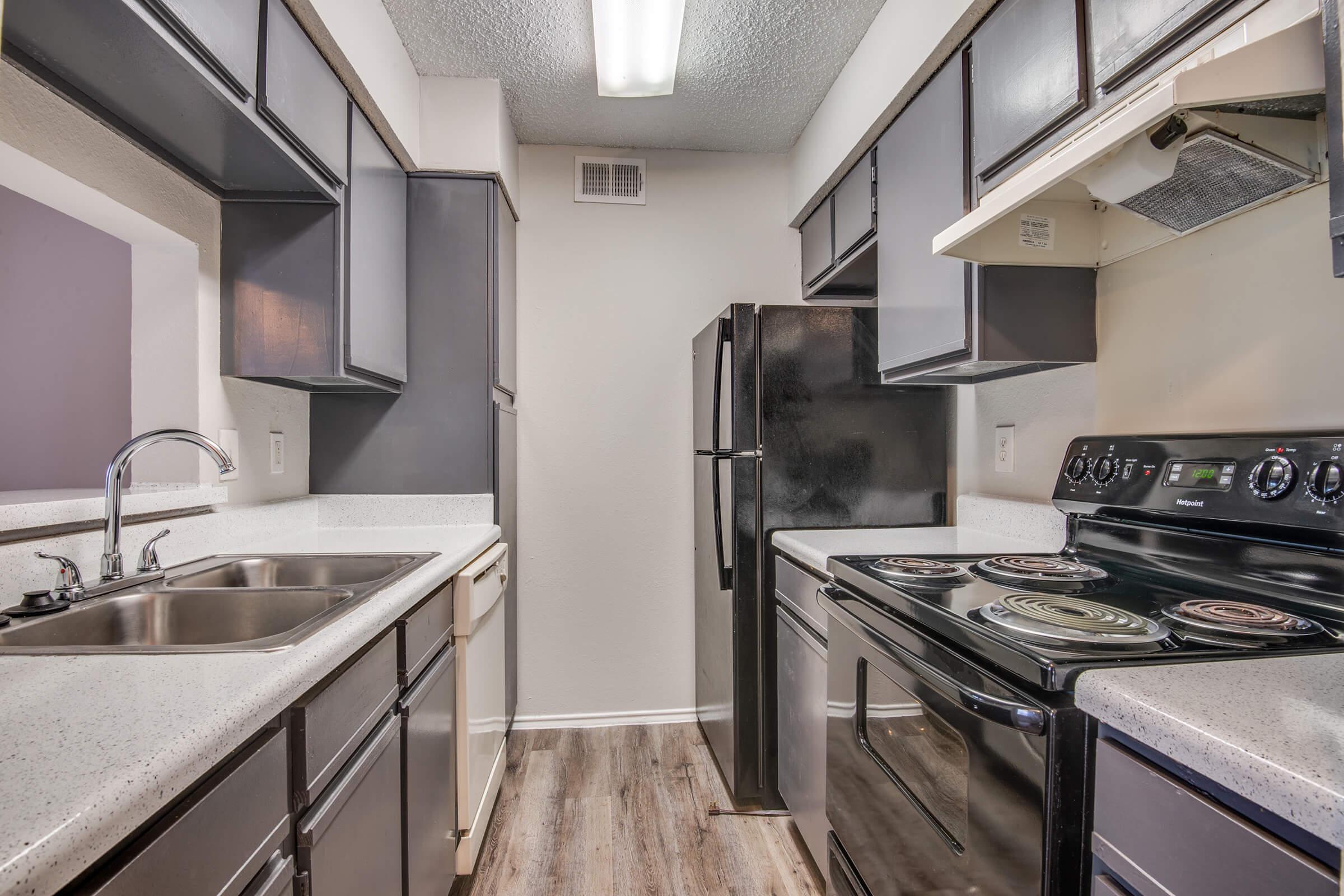 a kitchen with a stove and a sink