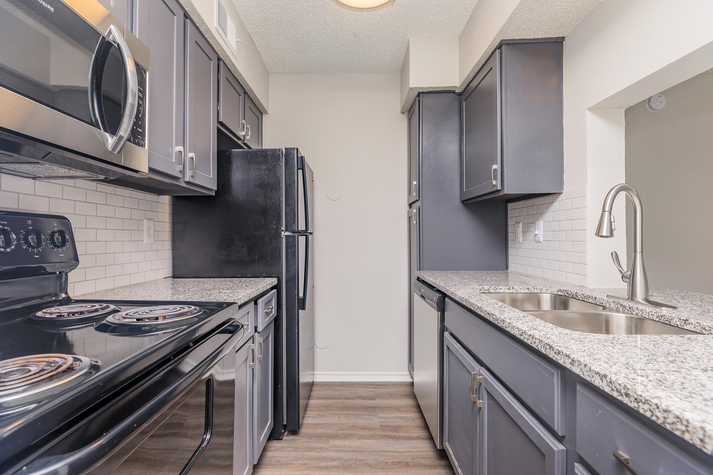 a large kitchen with stainless steel appliances