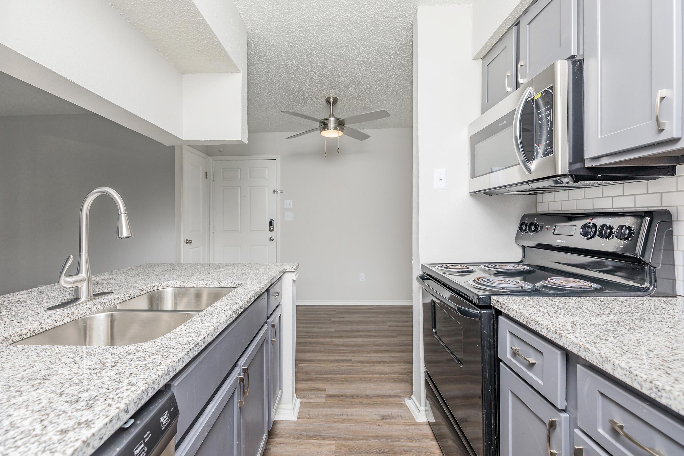 a kitchen with a stove and a sink