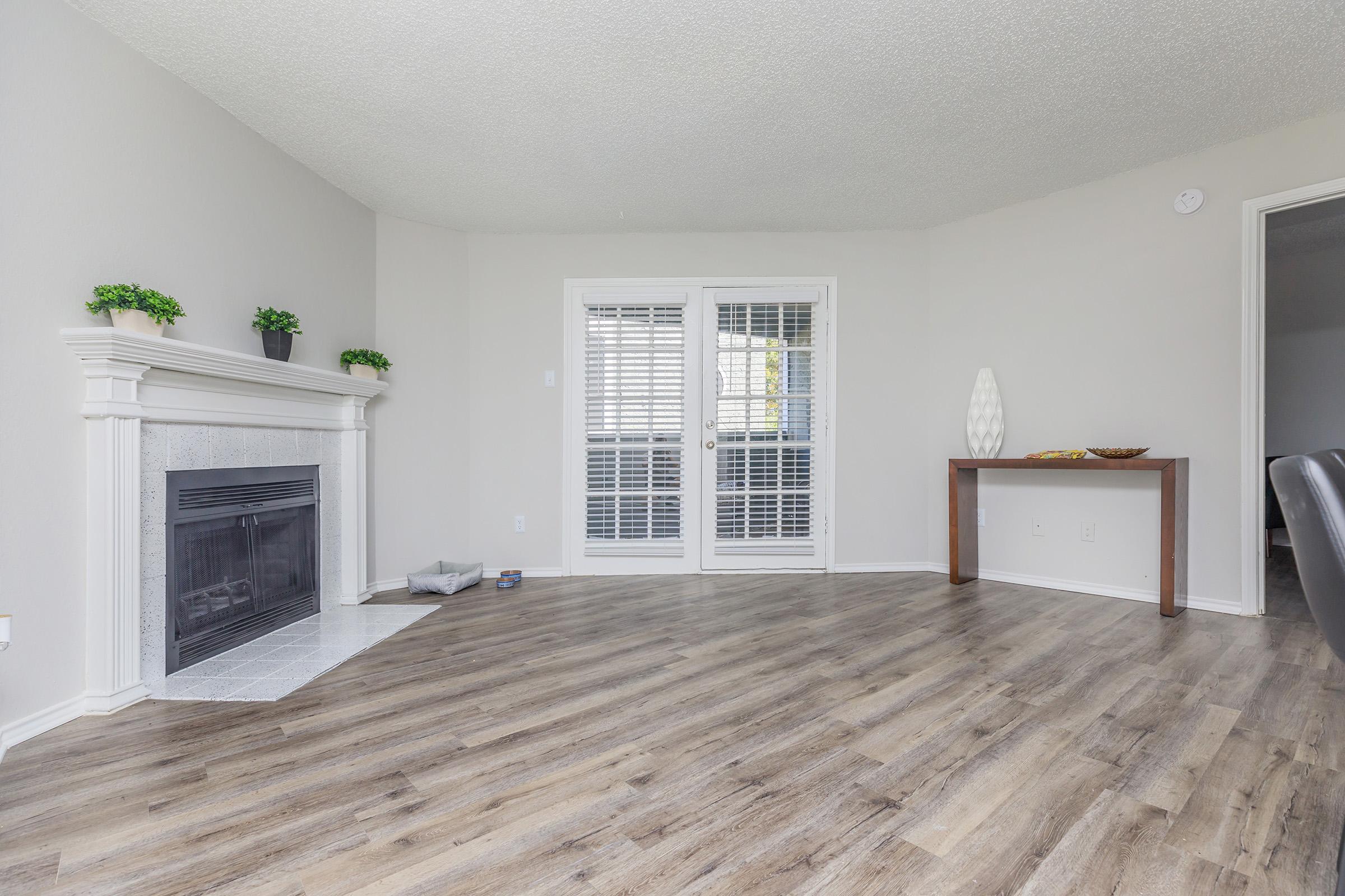 a living room filled with furniture and a large window