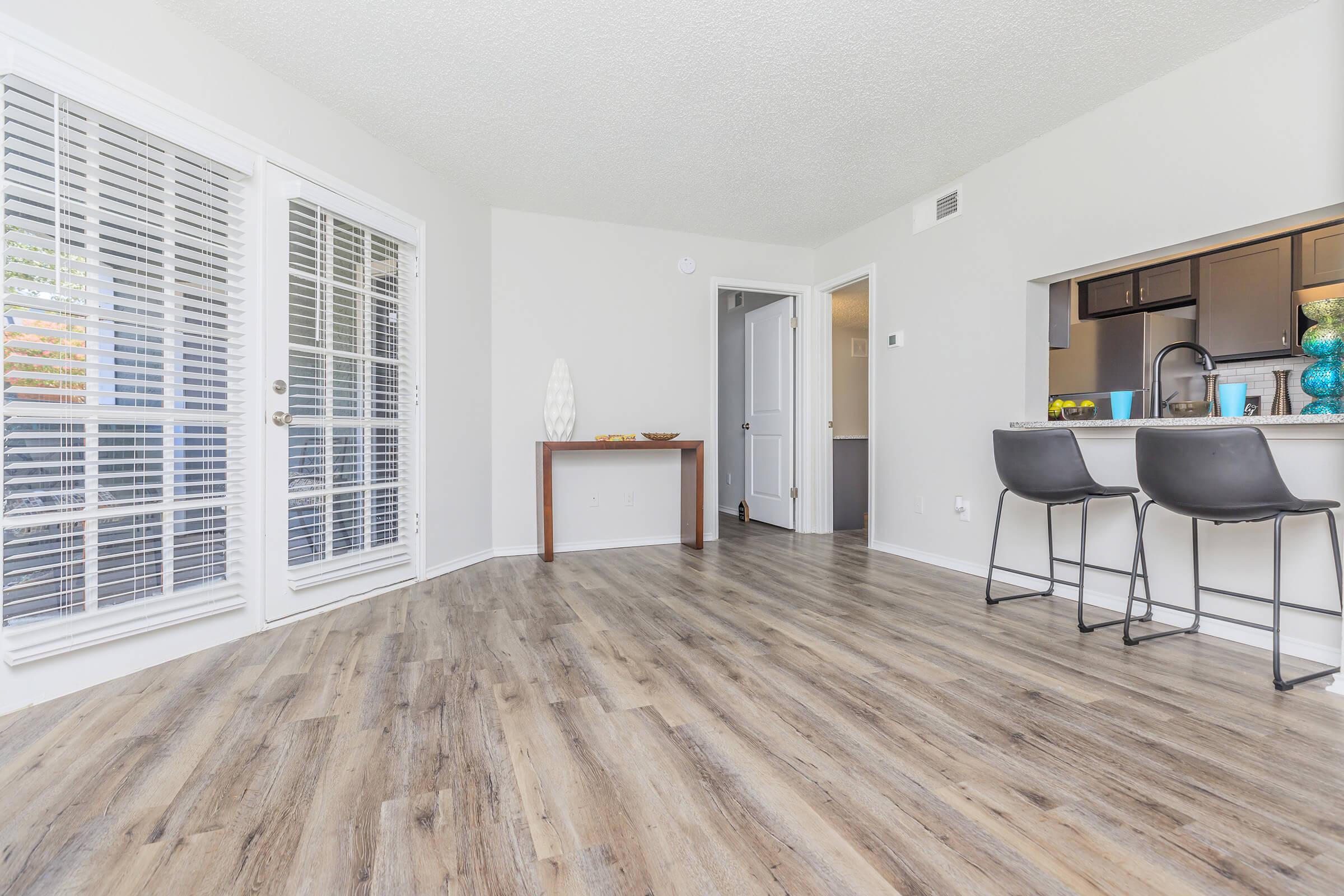 a living room filled with furniture and a large window