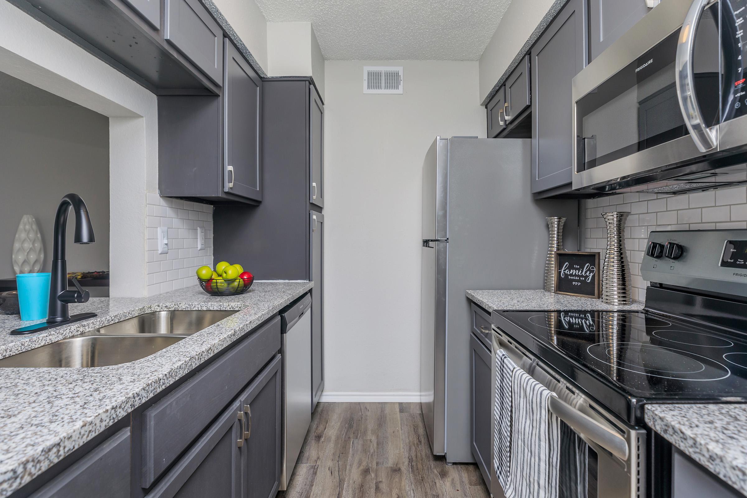 a large kitchen with stainless steel appliances