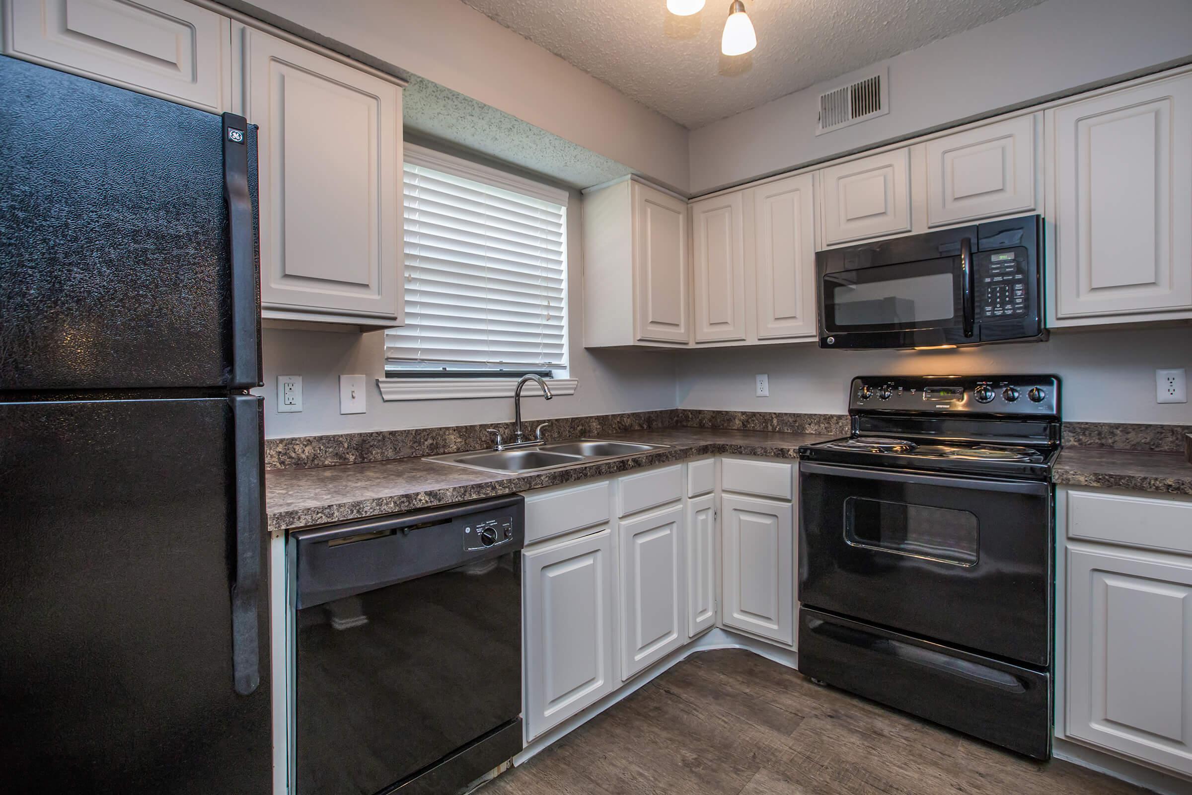 a stove top oven sitting inside of a kitchen