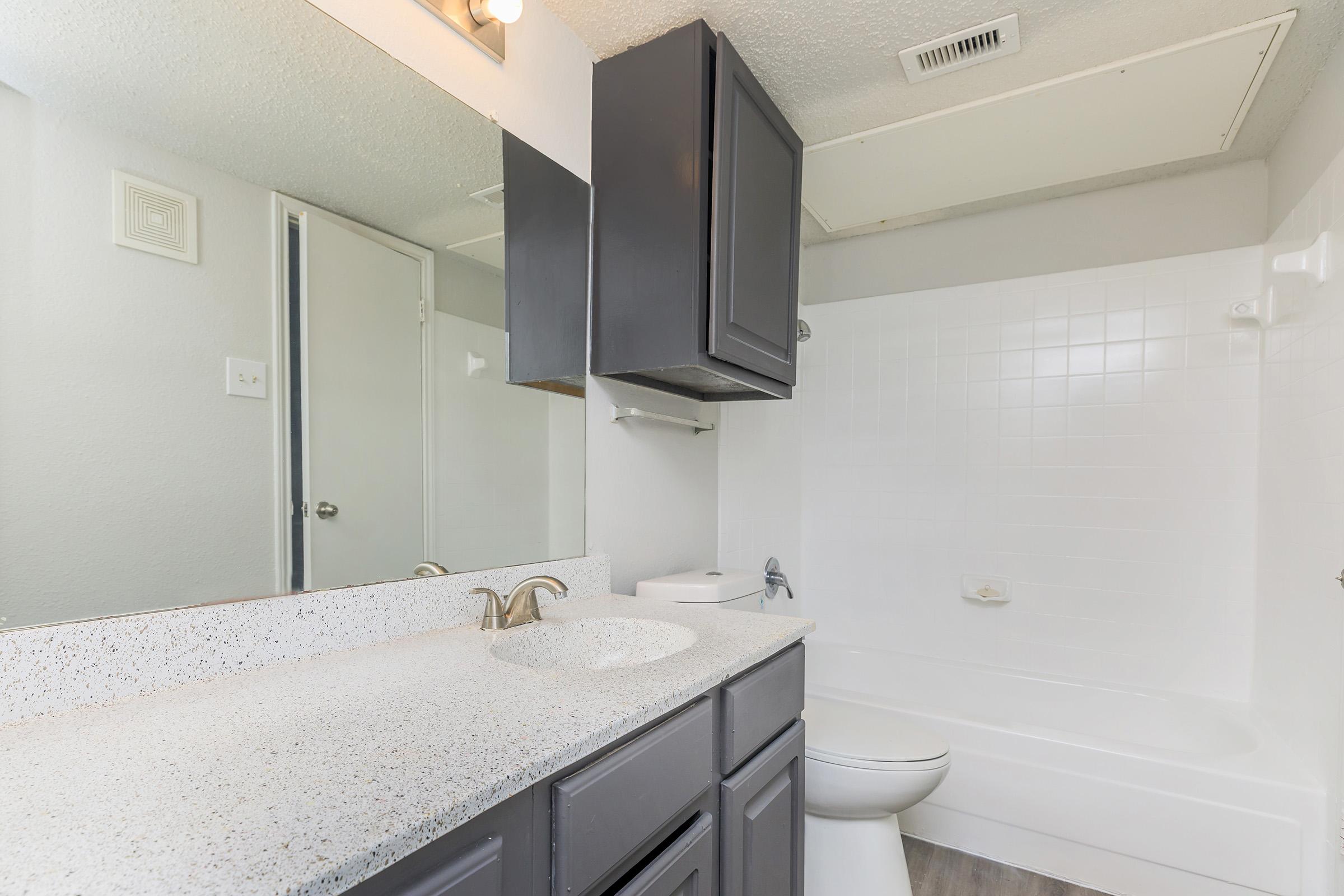 a kitchen with a sink and a mirror