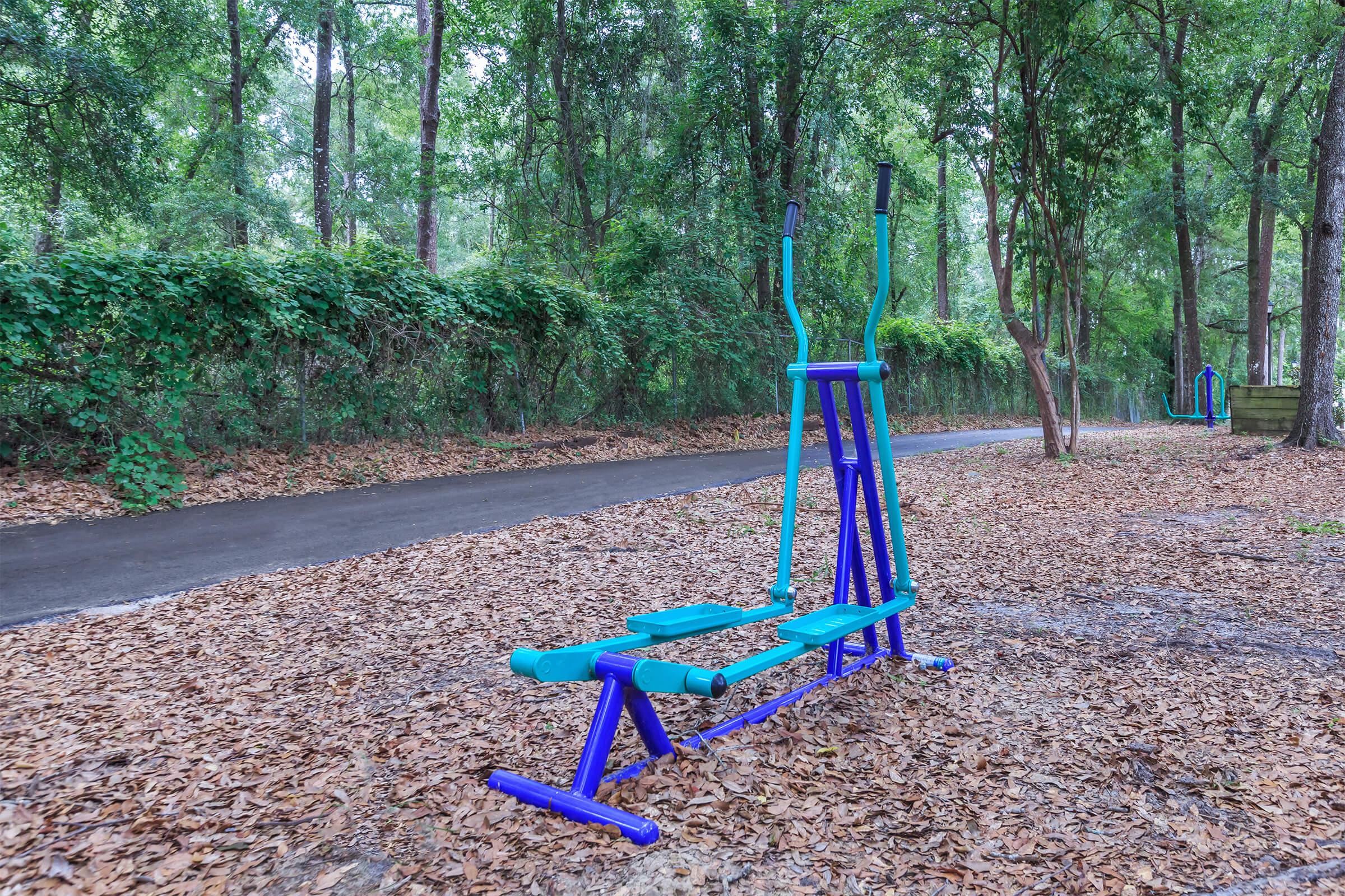 a bench in front of a forest