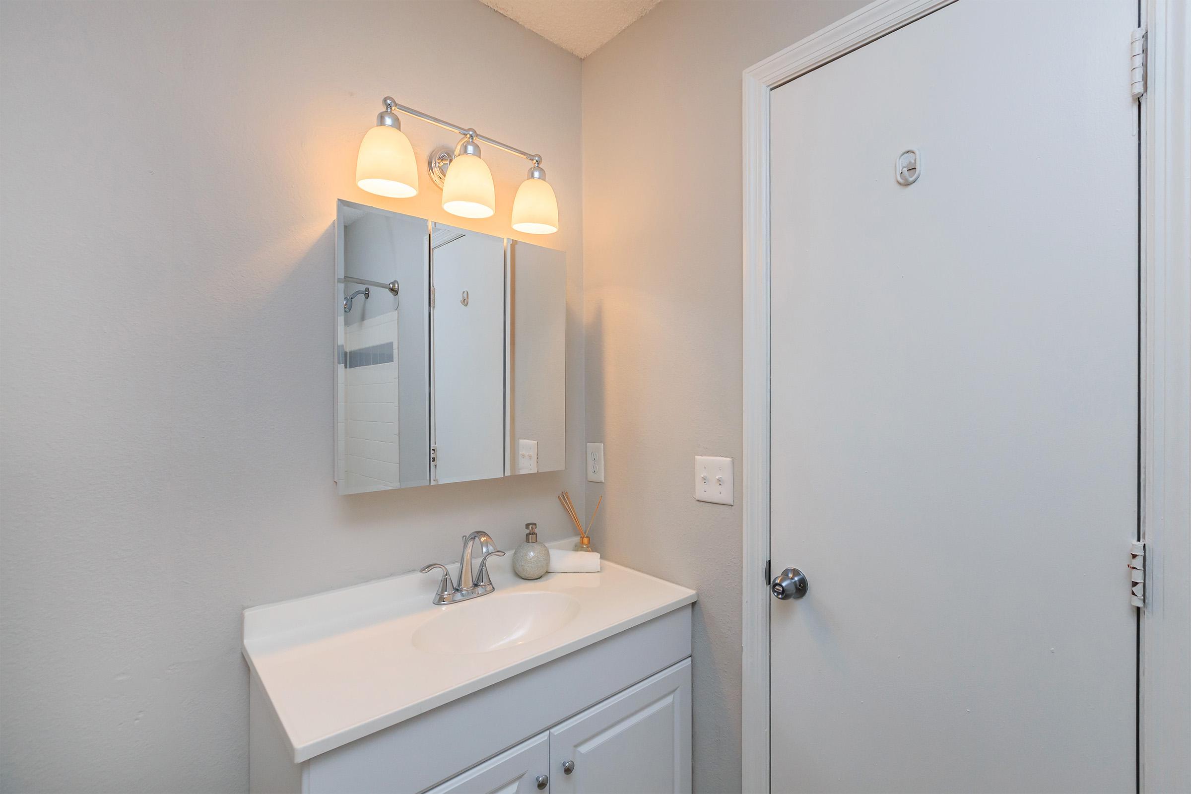 a room with a sink and a mirror